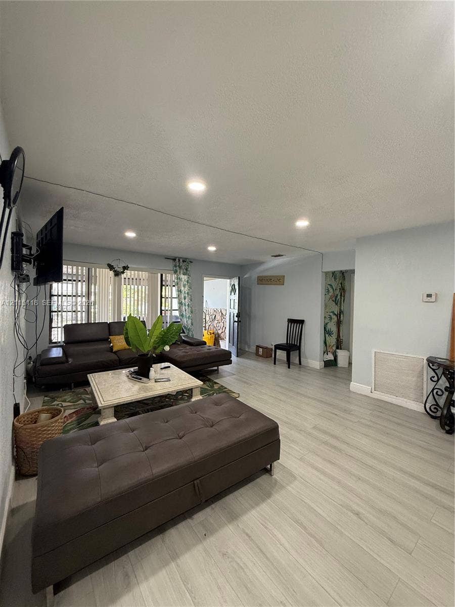 2816 SW 4th Place, #A, Fort Lauderdale, Fort Lauderdale, FL 33312 Living space featuring wood-finish flooring, recessed lighting, and large windows with vertical blinds