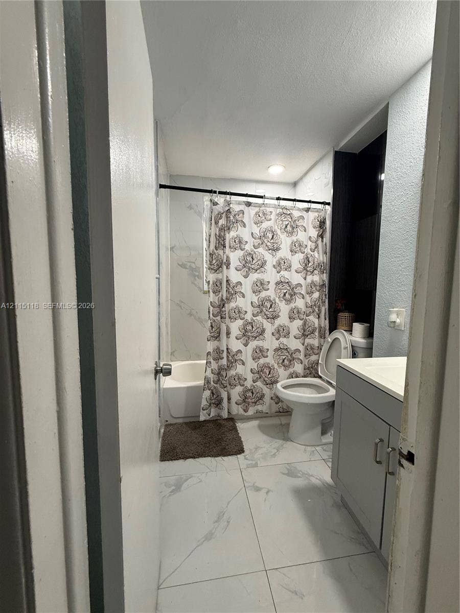 2816 SW 4th Place, #A, Fort Lauderdale, Fort Lauderdale, FL 33312 Bathroom featuring large-format tile flooring with a marble-finish, a grey vanity cabinet, and a shower-tub combination with tile surround