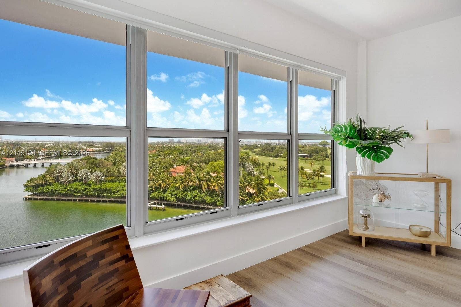 9102 W Bay Harbor Drive, #6-B, Bay Harbor Islands, Bay Harbor Islands, FL 33154 Floor-to-ceiling multi-panel windows, water and green space landscape backdrop, and wood-finish flooring
