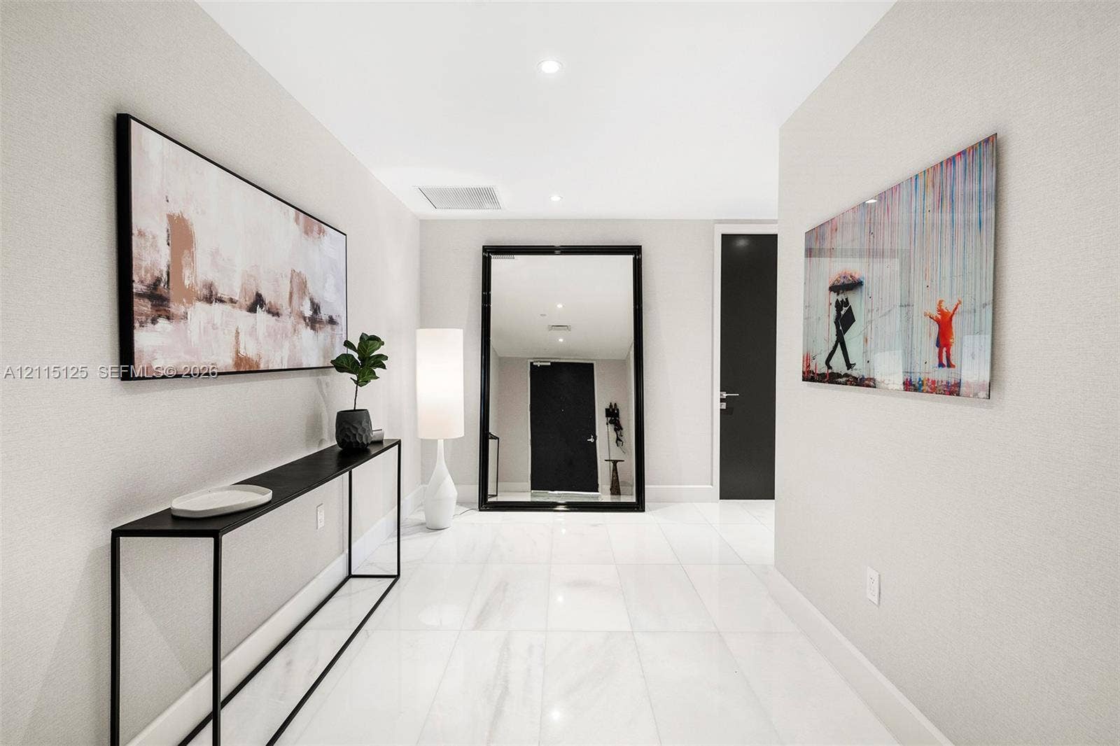 Foyer featuring large-format polished tile flooring, neutral wall tones, and recessed lighting