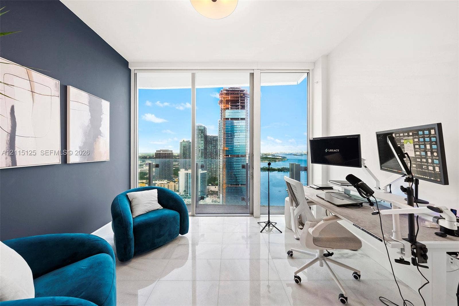 Floor-to-ceiling glass sliding doors, polished tile flooring, accent wall, and built-in flush-mount ceiling lighting