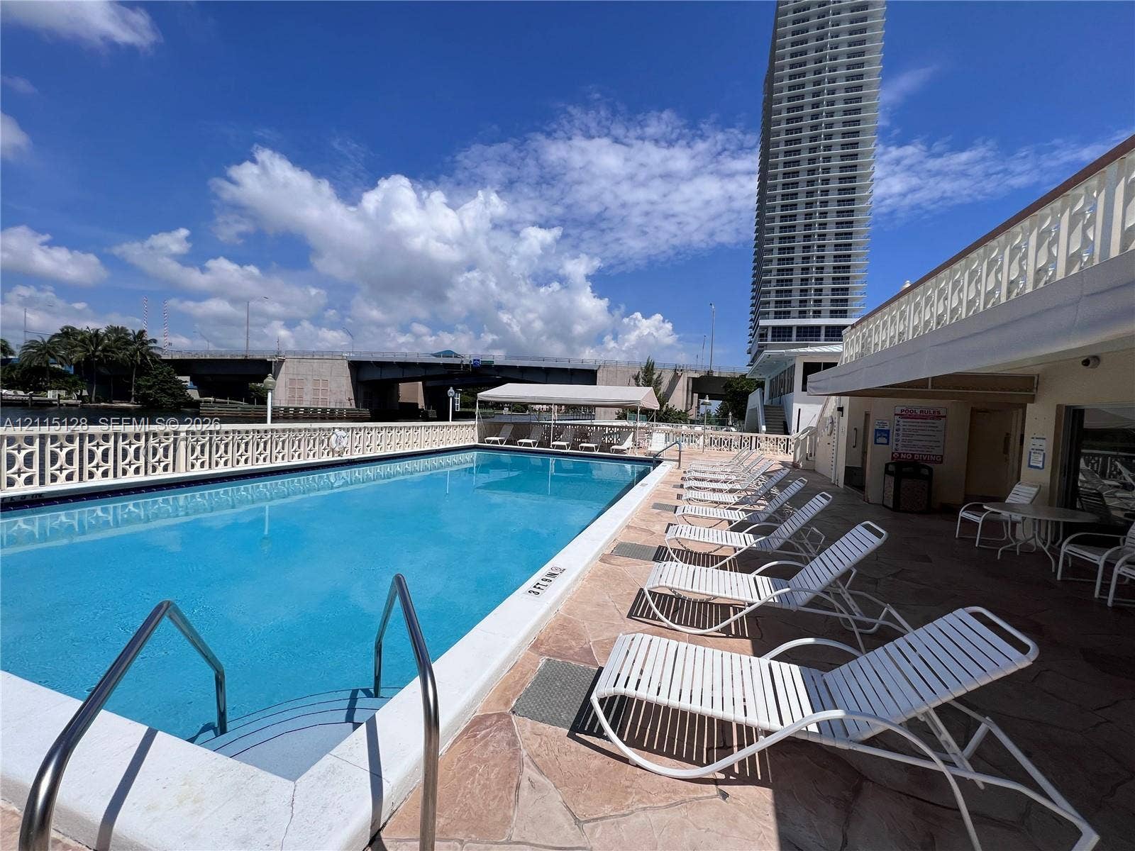 1817 S Ocean Drive, #426, Hallandale Beach, FL 33009 Swimming pool with stone paver decking and decorative lattice railing