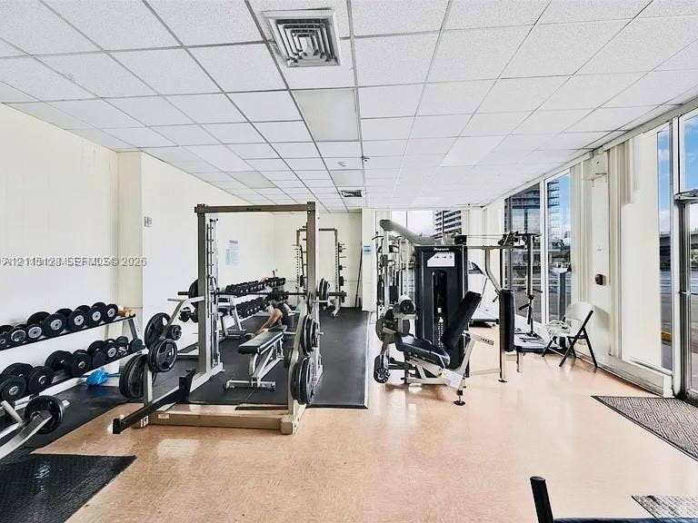 1817 S Ocean Drive, #426, Hallandale Beach, FL 33009 Fitness center featuring floor-to-ceiling windows, rubberized flooring, and drop ceiling panels
