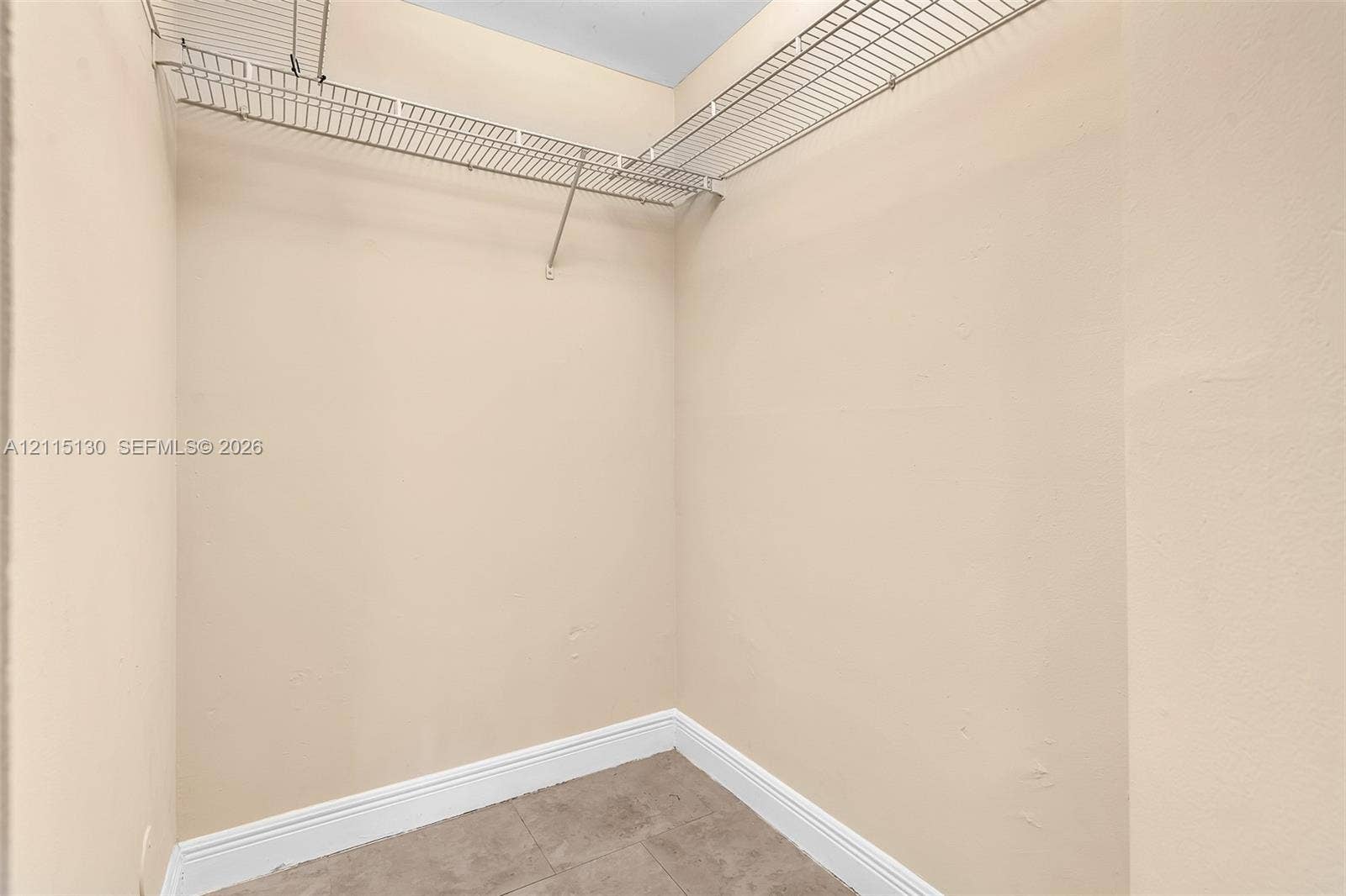 2445 SW 18th Terrace, #412, Fort Lauderdale, FL 33315 Storage space featuring neutral wall tones, tile flooring, and installed white wire shelving