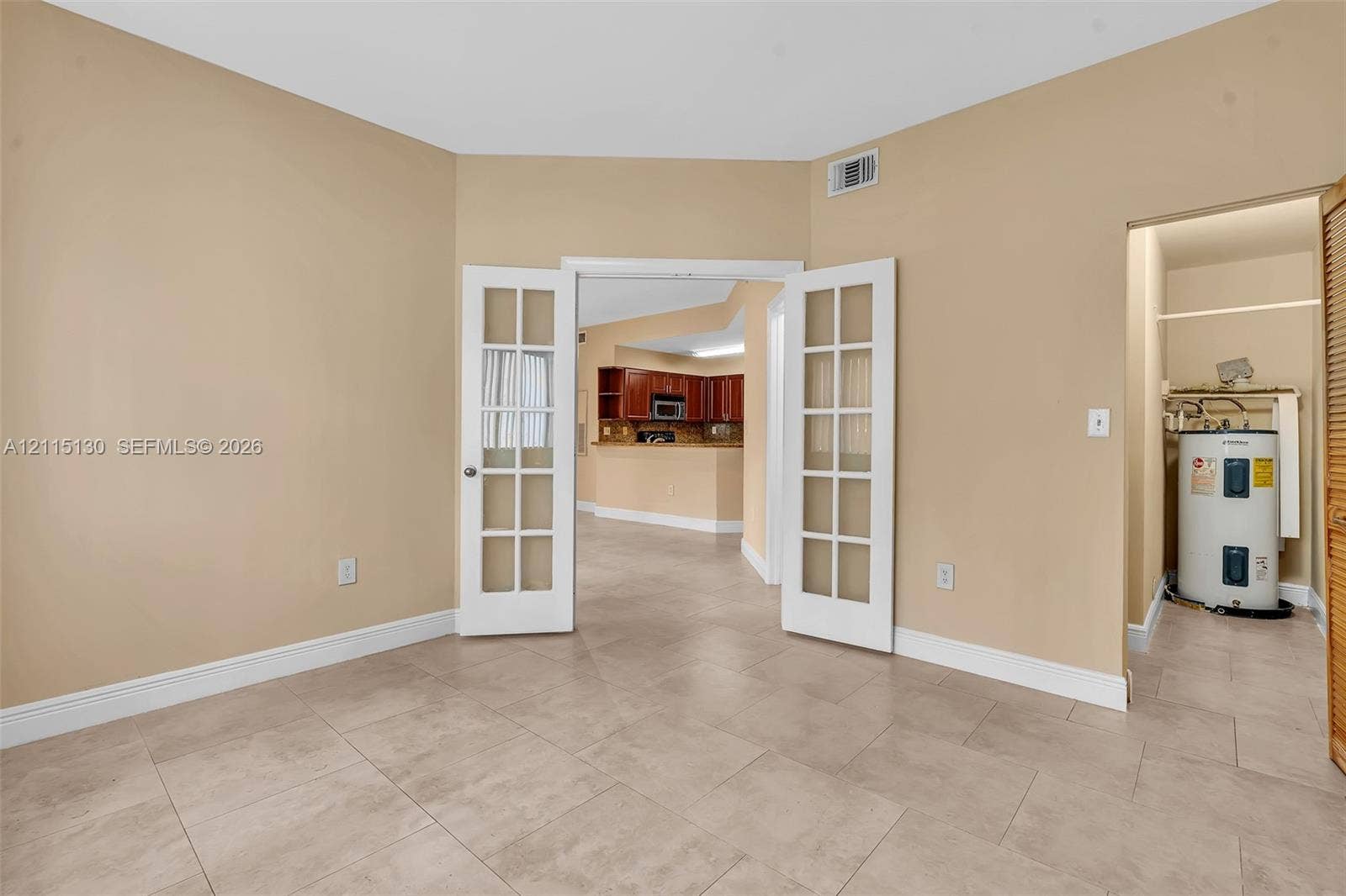 2445 SW 18th Terrace, #412, Fort Lauderdale, FL 33315 Room featuring large-format ceramic tile flooring and white French doors with glass panes