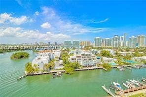 400 Kings Point Drive, #317, Sunny Isles Beach, FL 33160 Waterfront property featuring private boat slips, multi-level residential structures, and mature coastal landscaping