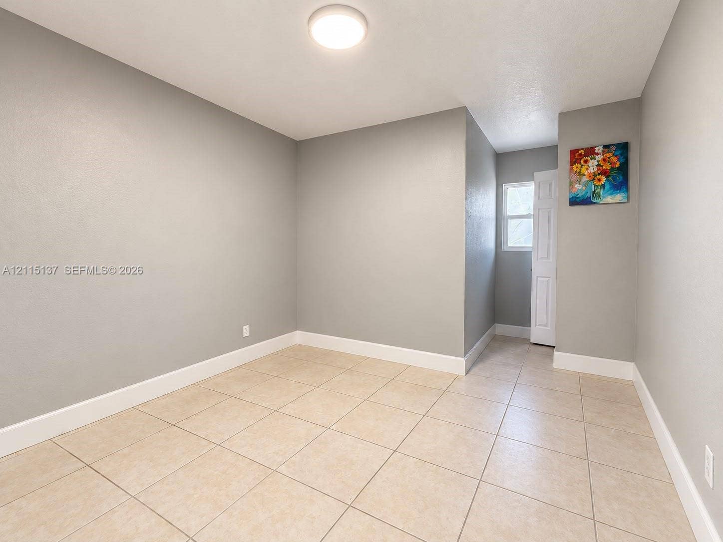 7870 SW 10th Court, #A, North Lauderdale, North Lauderdale, FL 33068 Neutral-toned wall finish, large-format neutral floor tiling, flush-mount ceiling lighting, and a multi-panel interior door