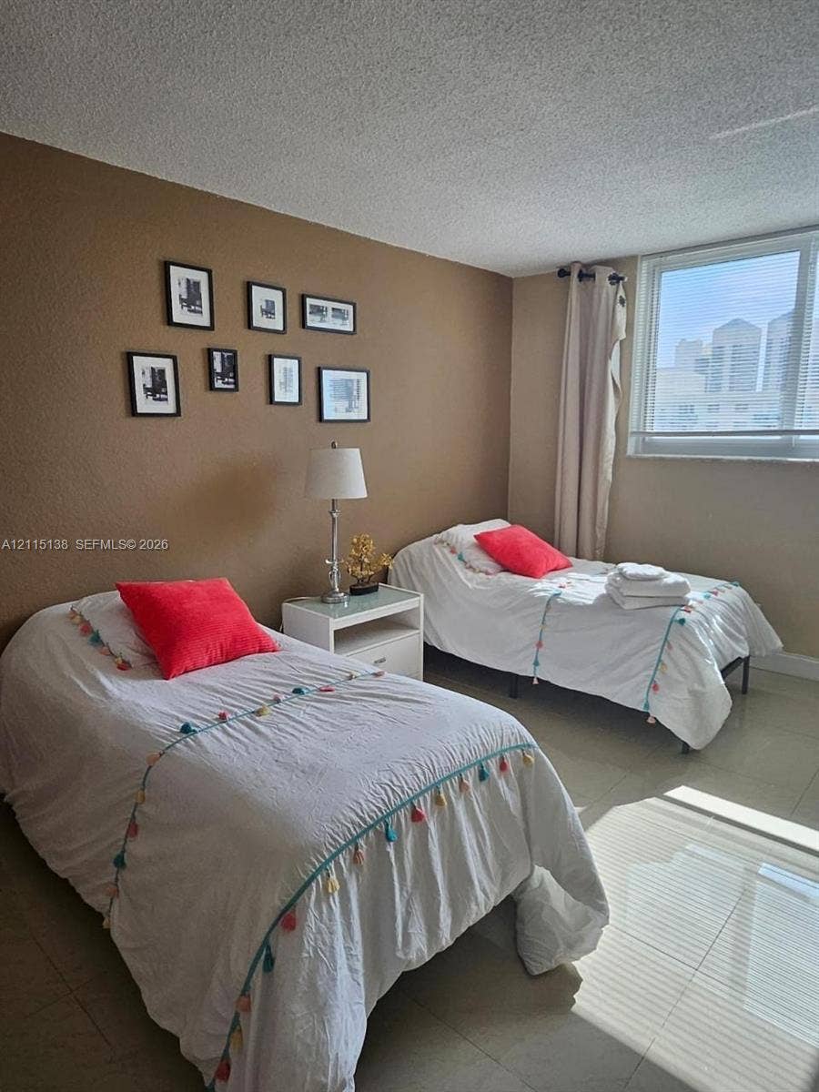 19380 Collins Avenue, #1602, Sunny Isles Beach, FL 33160 Room featuring neutral-toned walls, tile flooring, and a large window