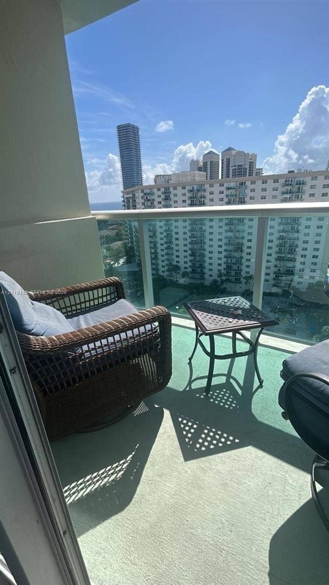 19380 Collins Avenue, #1602, Sunny Isles Beach, FL 33160 Covered balcony featuring a glass panel railing and solid surface flooring