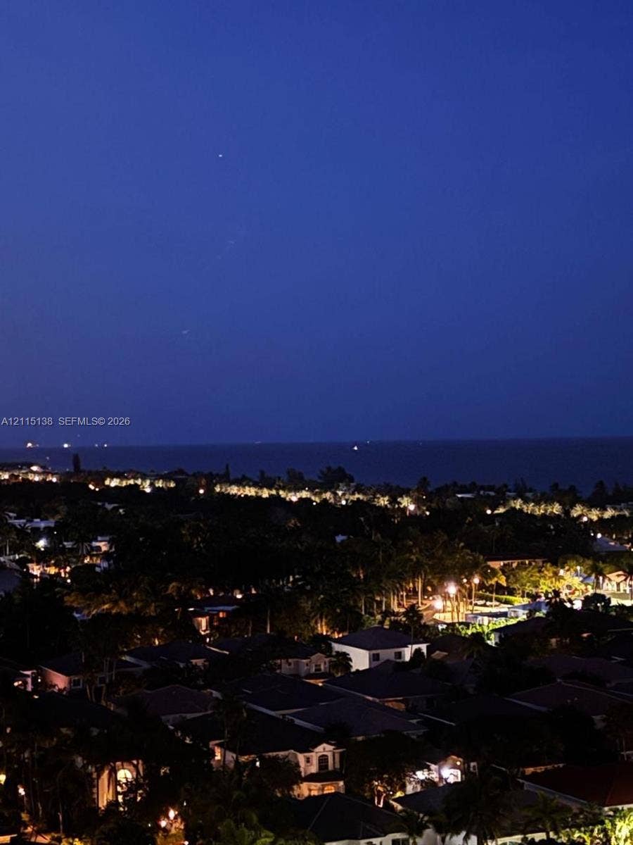 19380 Collins Avenue, #1602, Sunny Isles Beach, FL 33160 Elevated perspective of the coastal landscape featuring expansive water horizon and illuminated residential area