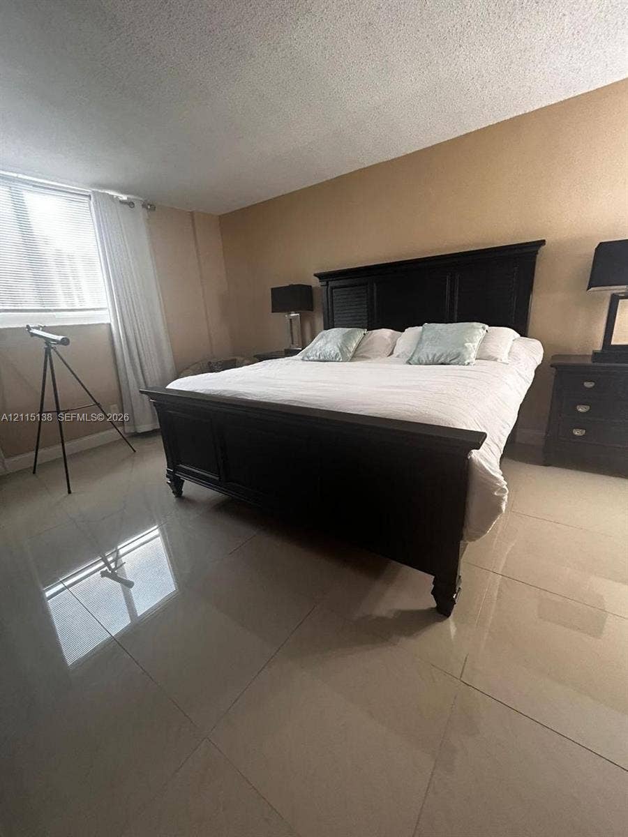 19380 Collins Avenue, #1602, Sunny Isles Beach, FL 33160 Large-format tile flooring and natural light from the expansive window