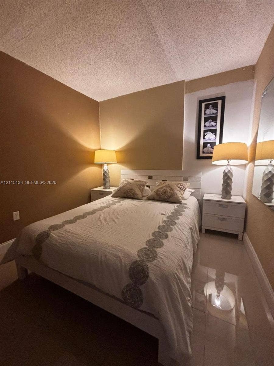 19380 Collins Avenue, #1602, Sunny Isles Beach, FL 33160 Neutral-toned walls paired with polished light-reflective flooring and a textured ceiling finish