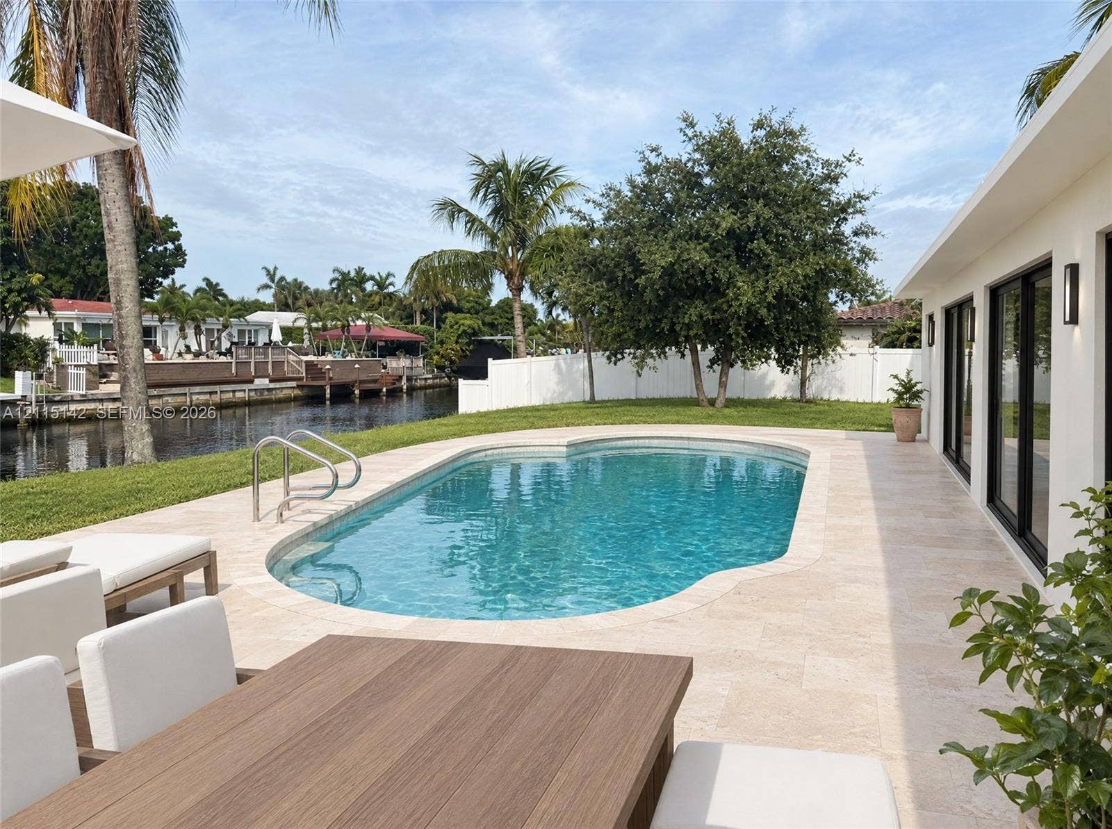 5940 SW 18th Street, Plantation, FL 33317 VIRTUAL RENDERING, NOT AN ACTUAL PHOTO. HOME IS UNDER CONSTRUCTION. Pool and terrace toward the canal shown as proposed per permitted plans; final construction, finishes, landscaping and furnishings may differ. Buyer to verify with developer.