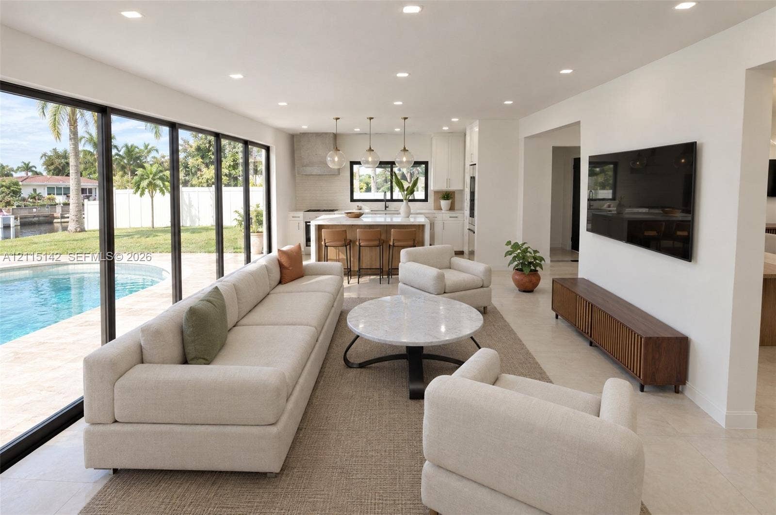 5940 SW 18th Street, Plantation, FL 33317 VIRTUAL RENDERING, NOT AN ACTUAL PHOTO. HOME IS UNDER CONSTRUCTION. Great room open to the pool shown as proposed per permitted plans; final construction, finishes, landscaping and furnishings may differ. Buyer to verify with developer.