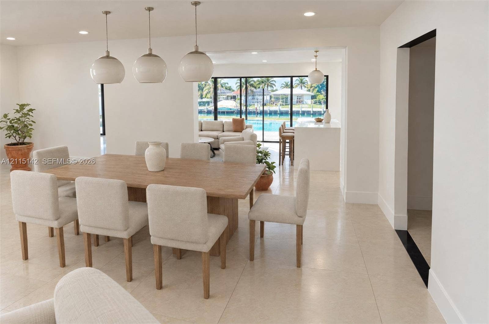 5940 SW 18th Street, Plantation, FL 33317 VIRTUAL RENDERING, NOT AN ACTUAL PHOTO. HOME IS UNDER CONSTRUCTION. Dining area with canal-side windows shown as proposed per permitted plans; final construction, finishes, landscaping and furnishings may differ. Buyer to verify with developer.