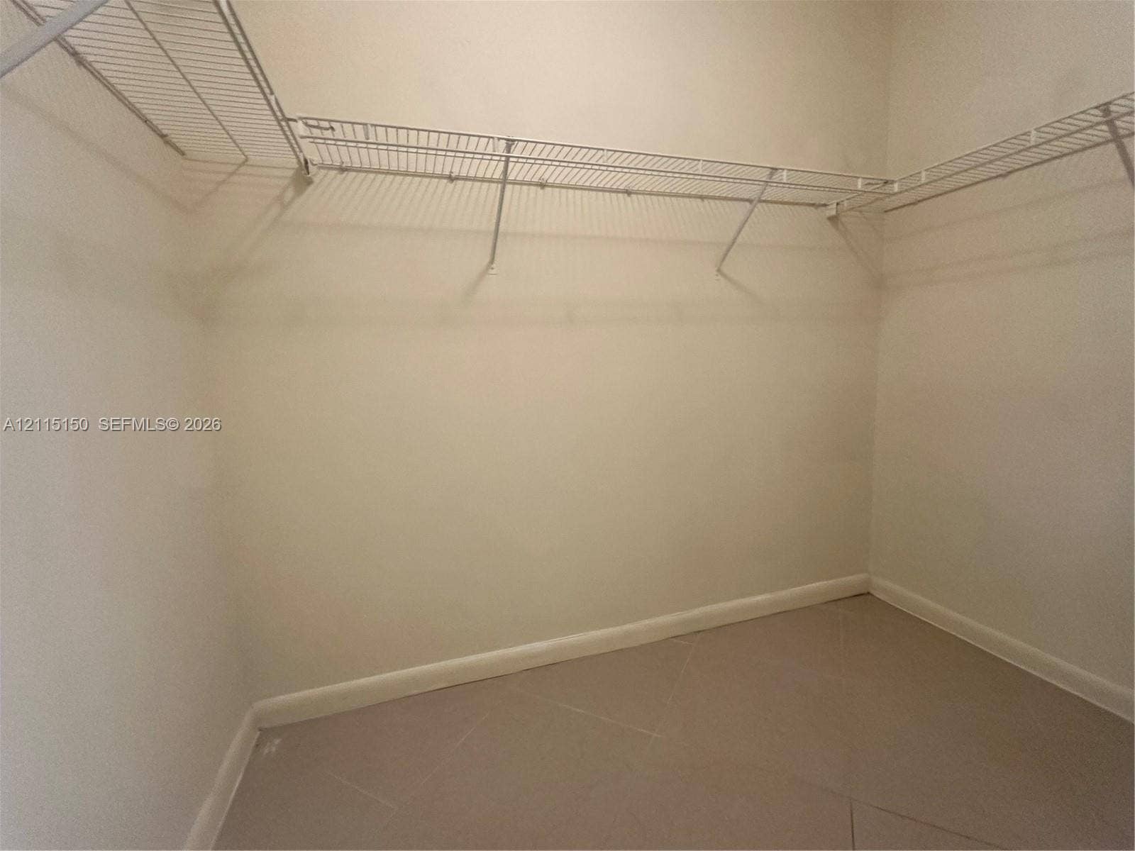 6992 SW 39th Street, #I201, Davie, Davie, FL 33314 Walk-in storage space featuring neutral tile flooring and multi-level white wire shelving