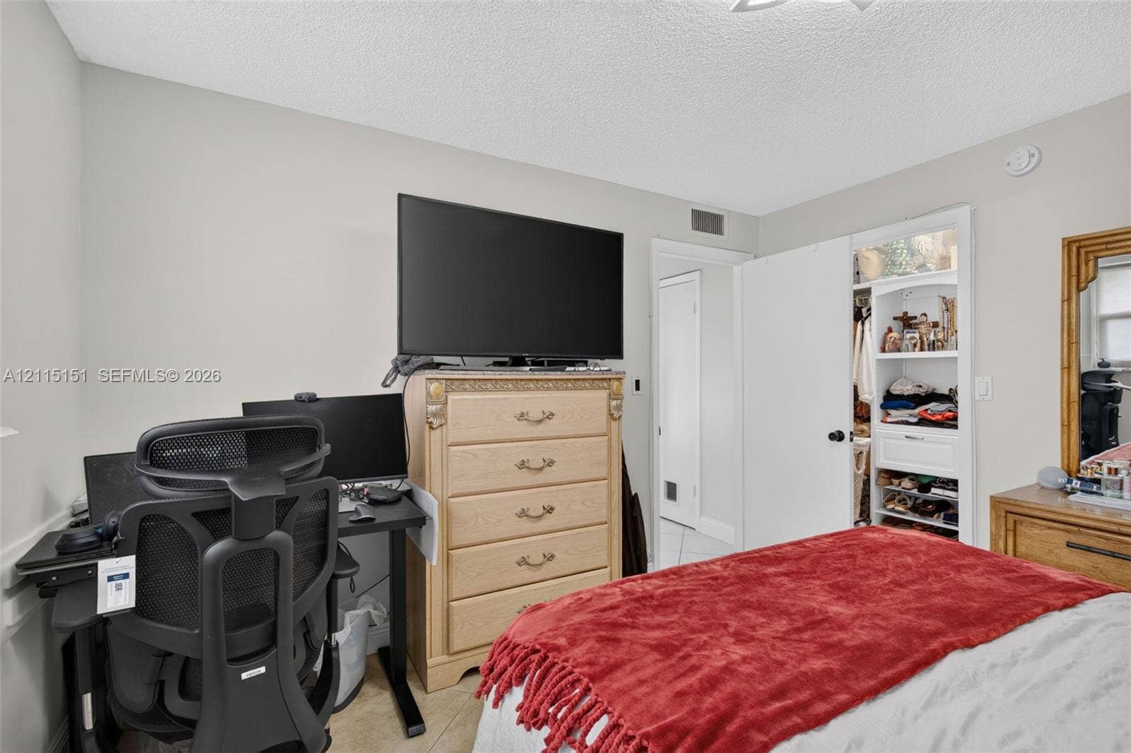 5951 NE 14th Lane, #408N, Fort Lauderdale, FL 33334 Built-in reach-in closet featuring white shaker-style cabinetry, open shelving, and a glass-paneled upper storage section
