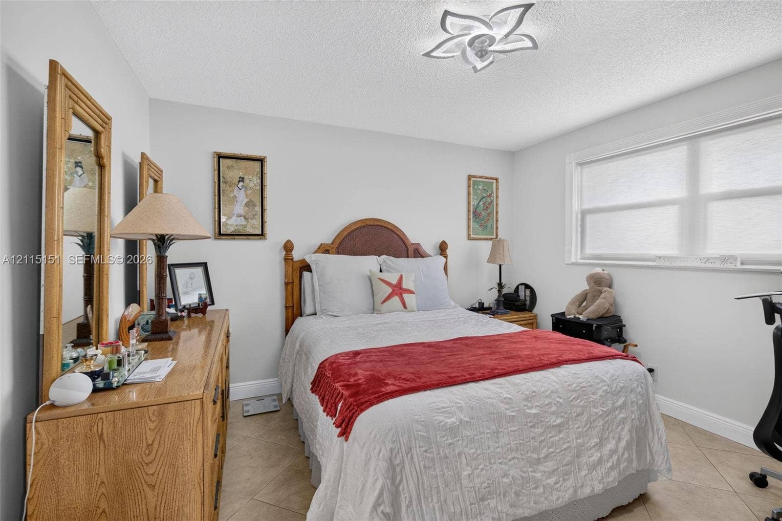 5951 NE 14th Lane, #408N, Fort Lauderdale, FL 33334 Room featuring neutral wall paint, large format tile flooring, and a decorative floral-shaped ceiling fixture