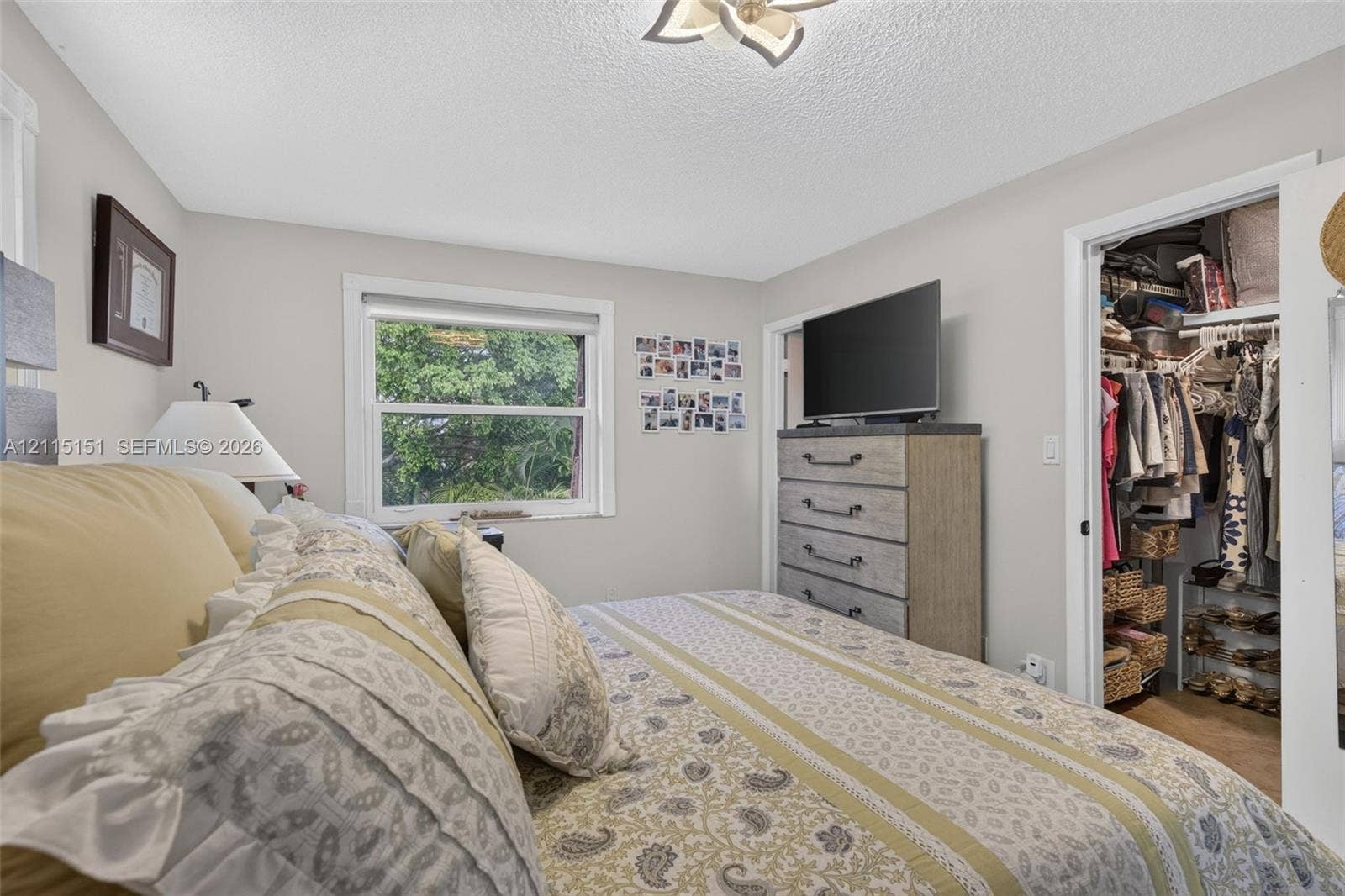 5951 NE 14th Lane, #408N, Fort Lauderdale, FL 33334 Neutral interior room featuring a single-hung window, white wall finish, and a ceiling-mounted light fixture with petal-inspired details