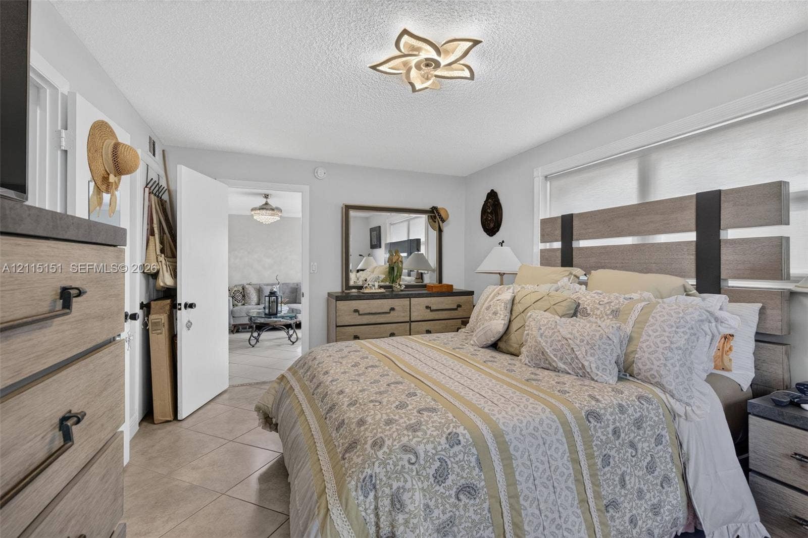 5951 NE 14th Lane, #408N, Fort Lauderdale, FL 33334 Ceramic tile flooring, multi-paneled window, and architectural floral-patterned flush-mount ceiling lighting