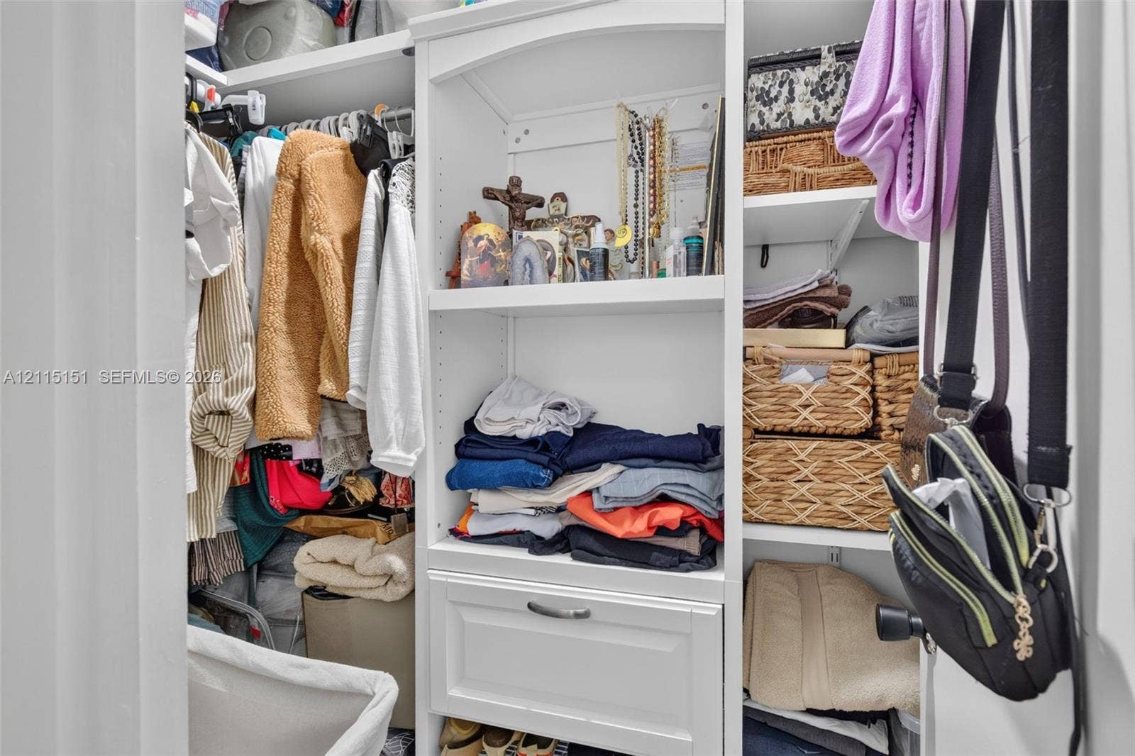 5951 NE 14th Lane, #408N, Fort Lauderdale, FL 33334 Custom built-in closet organization featuring adjustable shelving, integrated storage drawer, and overhead display nook