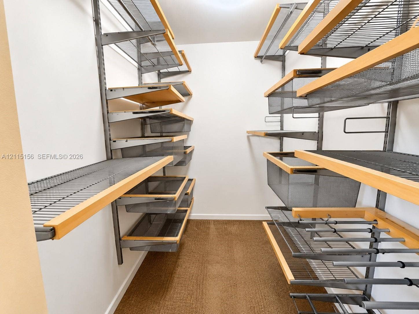 4800 NW 102nd Avenue, #201-10, Doral, Doral, FL 33178 Custom storage system featuring metal shelving units, integrated wood-trim shelving, slide-out wire baskets, and hanging rods