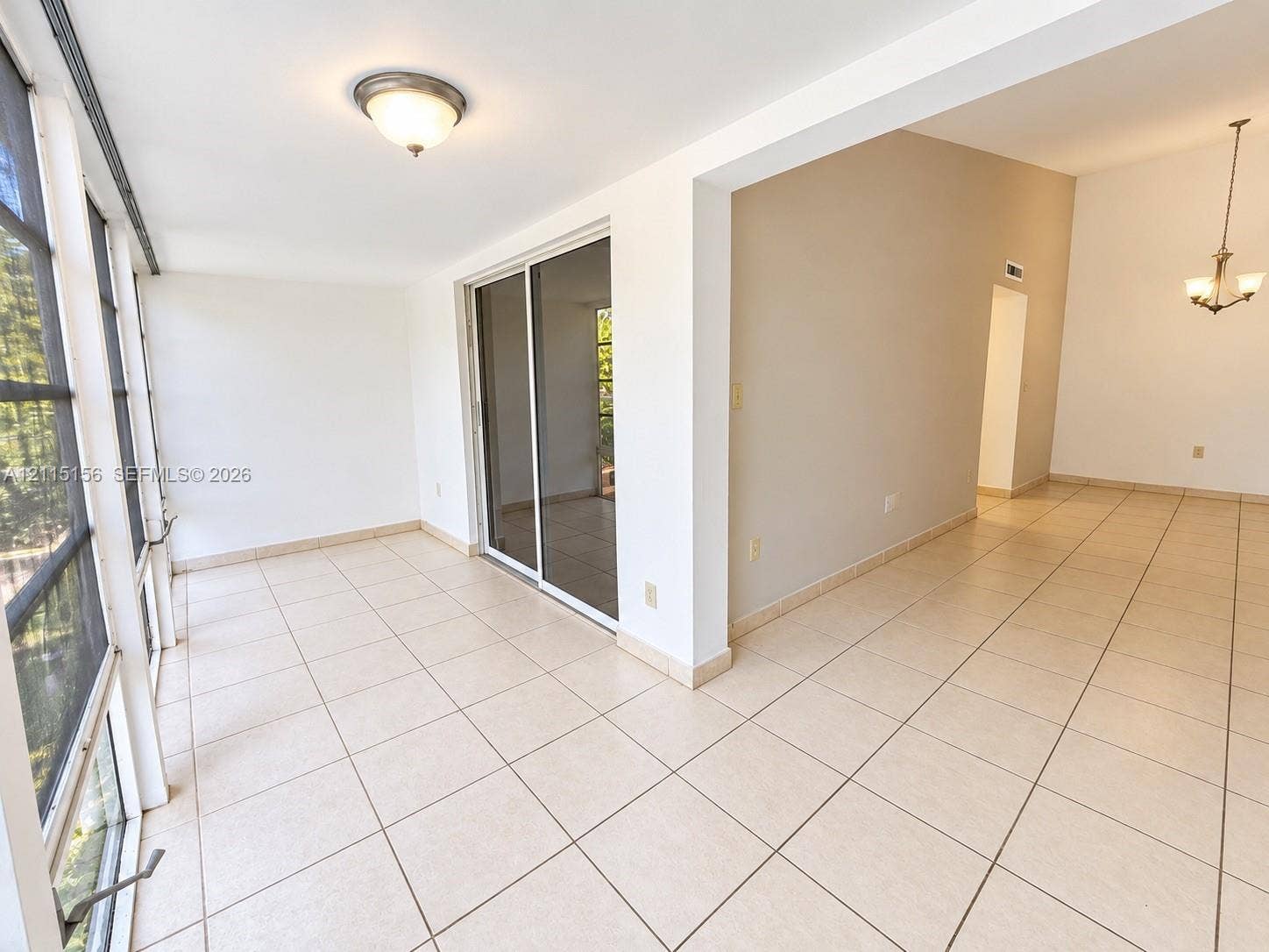 4800 NW 102nd Avenue, #201-10, Doral, Doral, FL 33178 Enclosed sunroom featuring tile flooring, expansive screen panels, sliding glass door, and overhead lighting