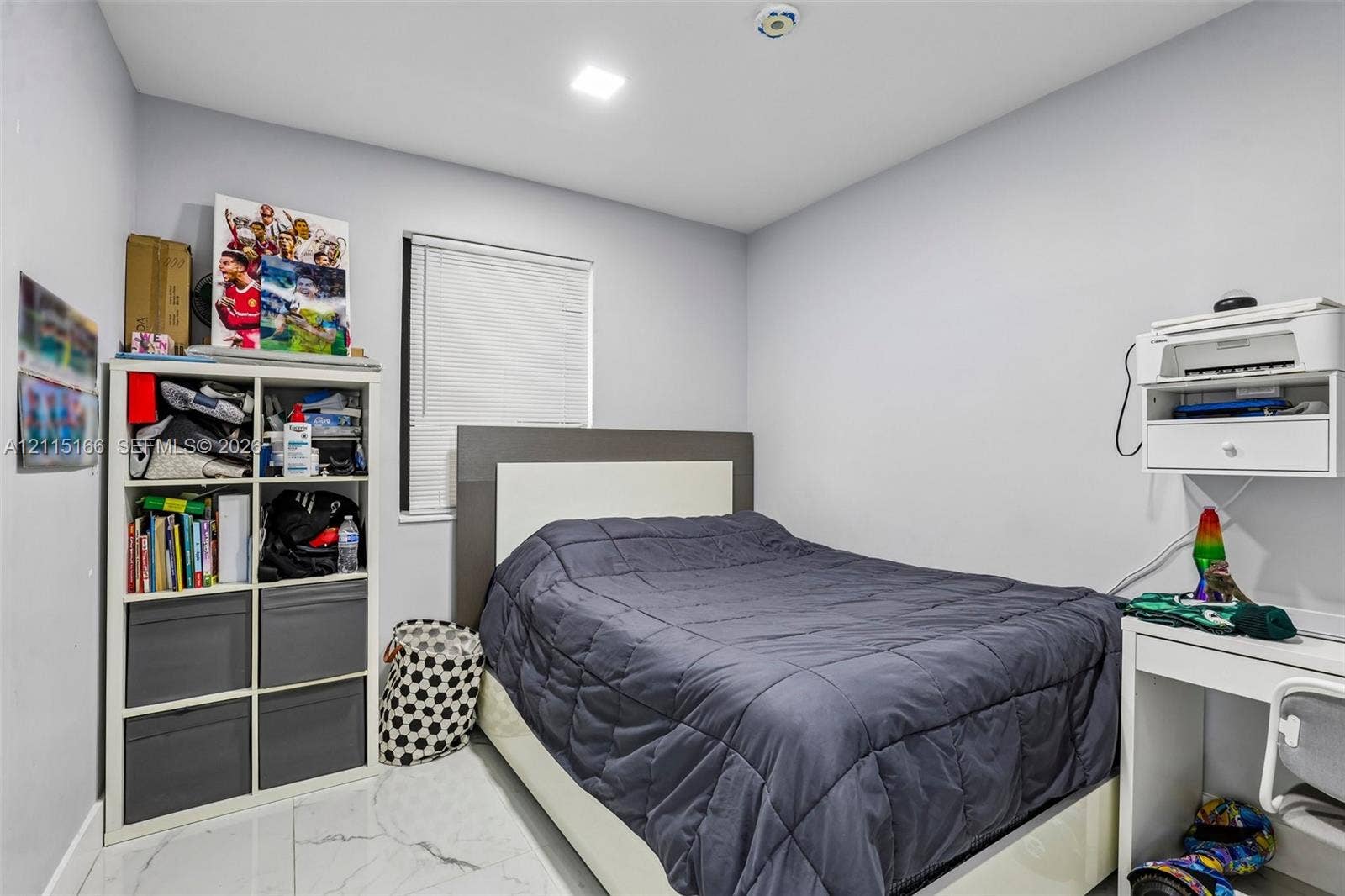 1421 N 68th Terrace, Hollywood, FL 33024 Neutral interior room featuring white stone-finish tile flooring, recessed ceiling lighting, and a window with horizontal blinds