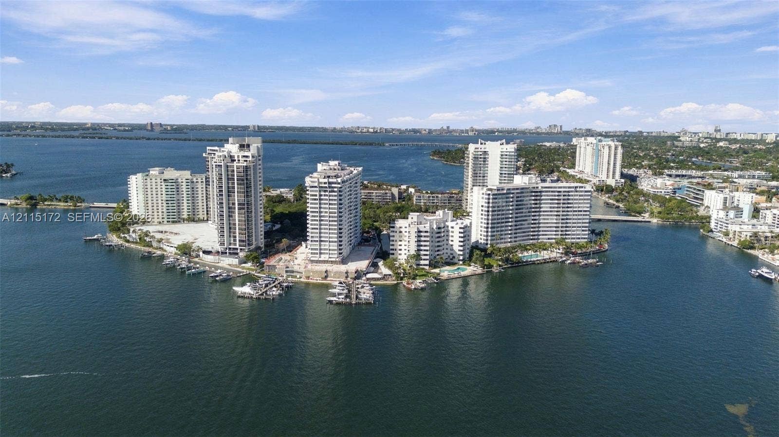 16 Island Avenue, #5C, Miami Beach, FL 33139 Aerial perspective of a waterfront peninsula featuring high-rise residential towers, deep-water dockage, and expansive maritime frontage