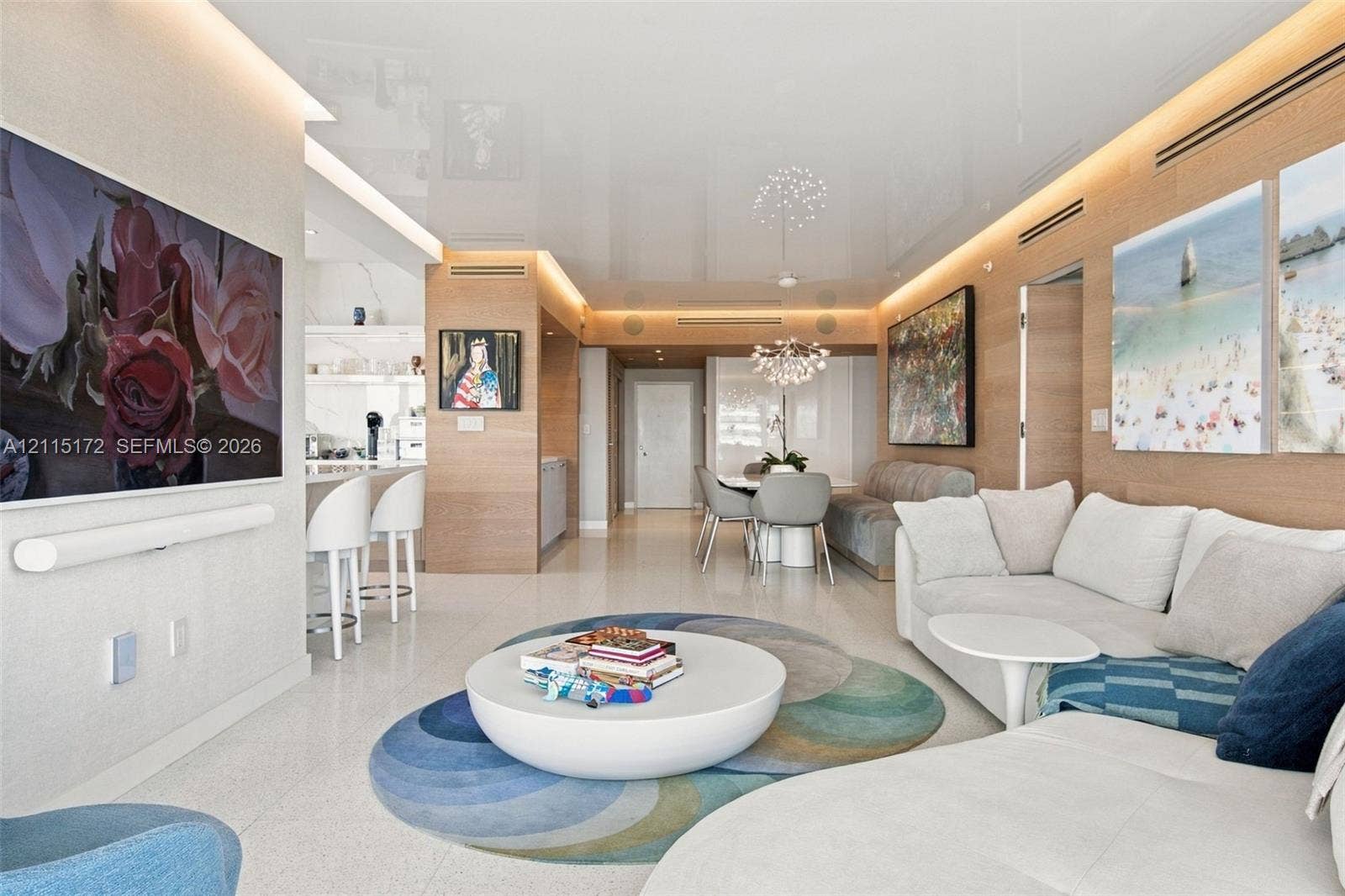 16 Island Avenue, #5C, Miami Beach, FL 33139 High-gloss ceiling with integrated perimeter recessed lighting, polished stone flooring, and warm wood-panel wall treatments