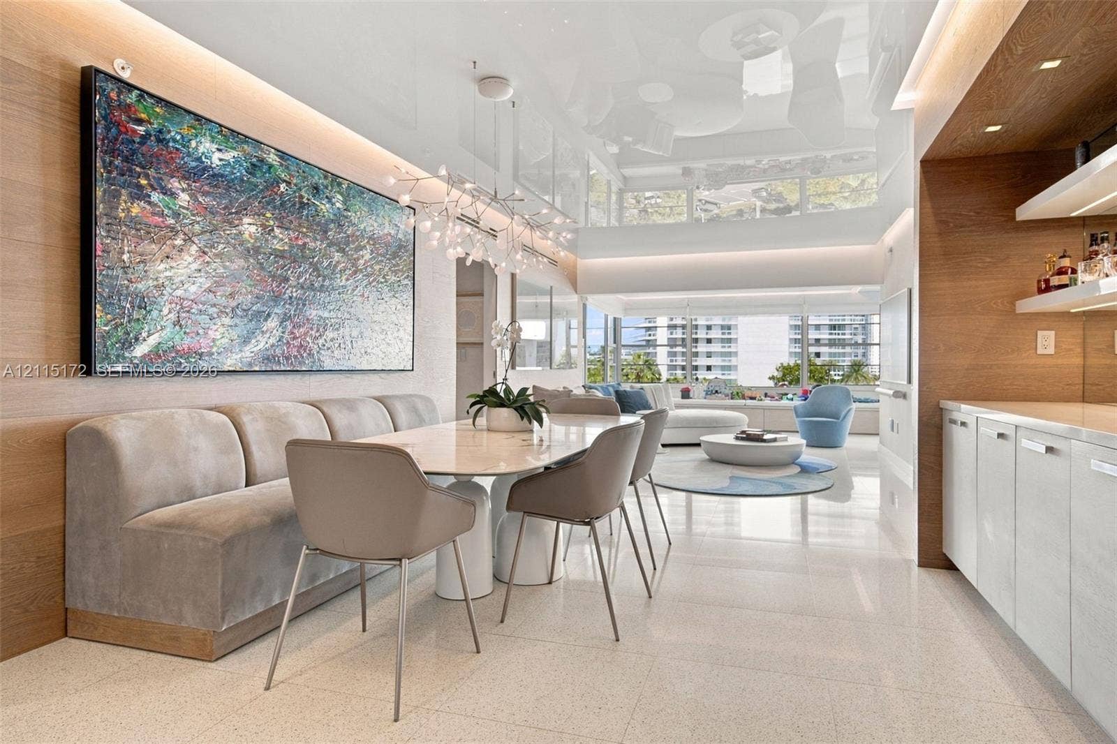 16 Island Avenue, #5C, Miami Beach, FL 33139 High-gloss ceiling with recessed perimeter lighting, wall-to-wall wood-finish paneling, custom built-in cabinetry with stone-finish countertops, and large-format tile flooring