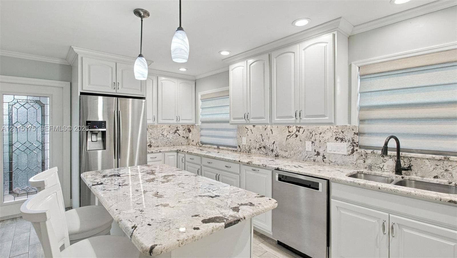 324 Seville N, Delray Beach, FL 33446 Kitchen featuring white cabinetry, quartz countertops, stainless steel appliances and a central island