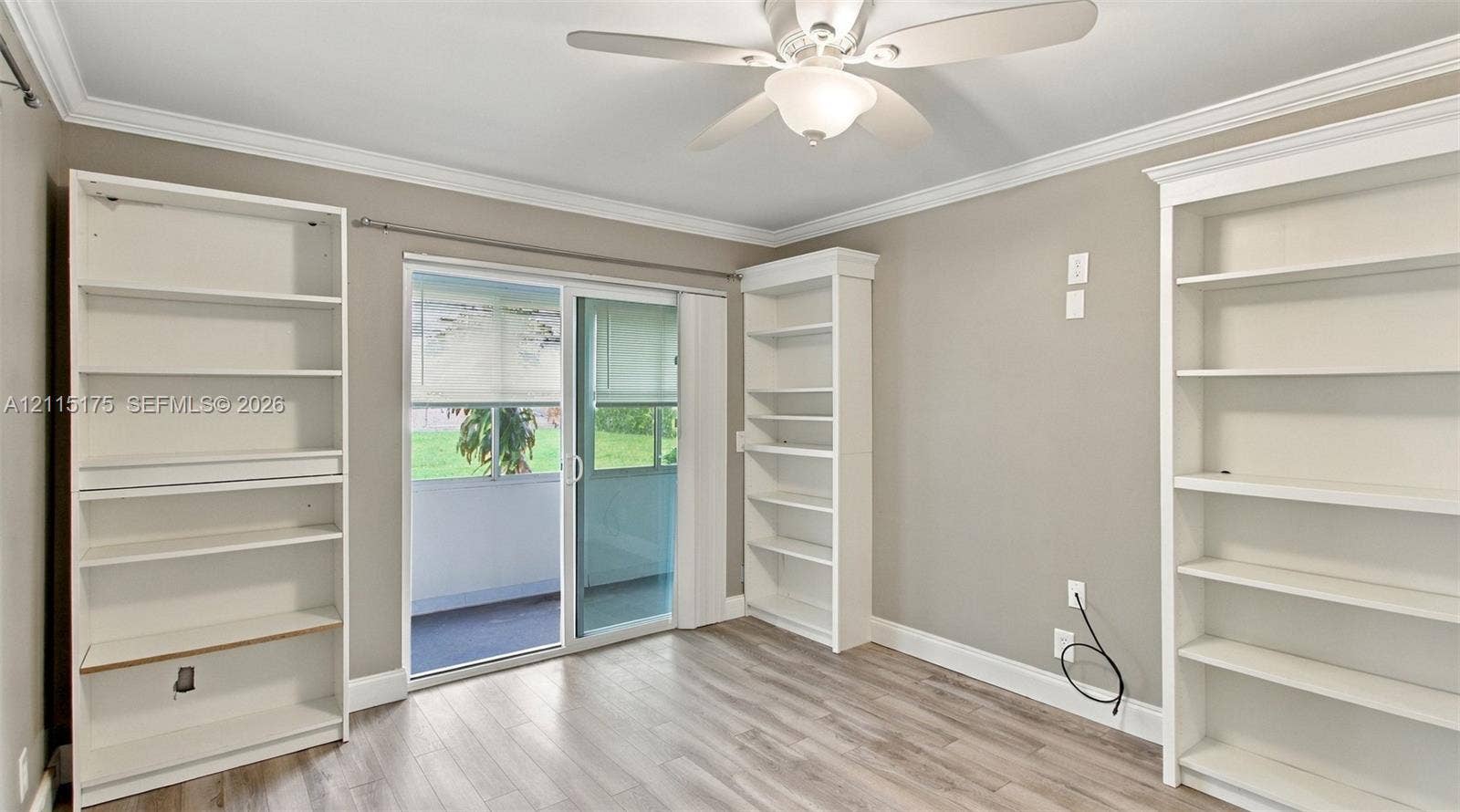 324 Seville N, Delray Beach, FL 33446 Second bedroom with sliding glass doors leading to lanai.