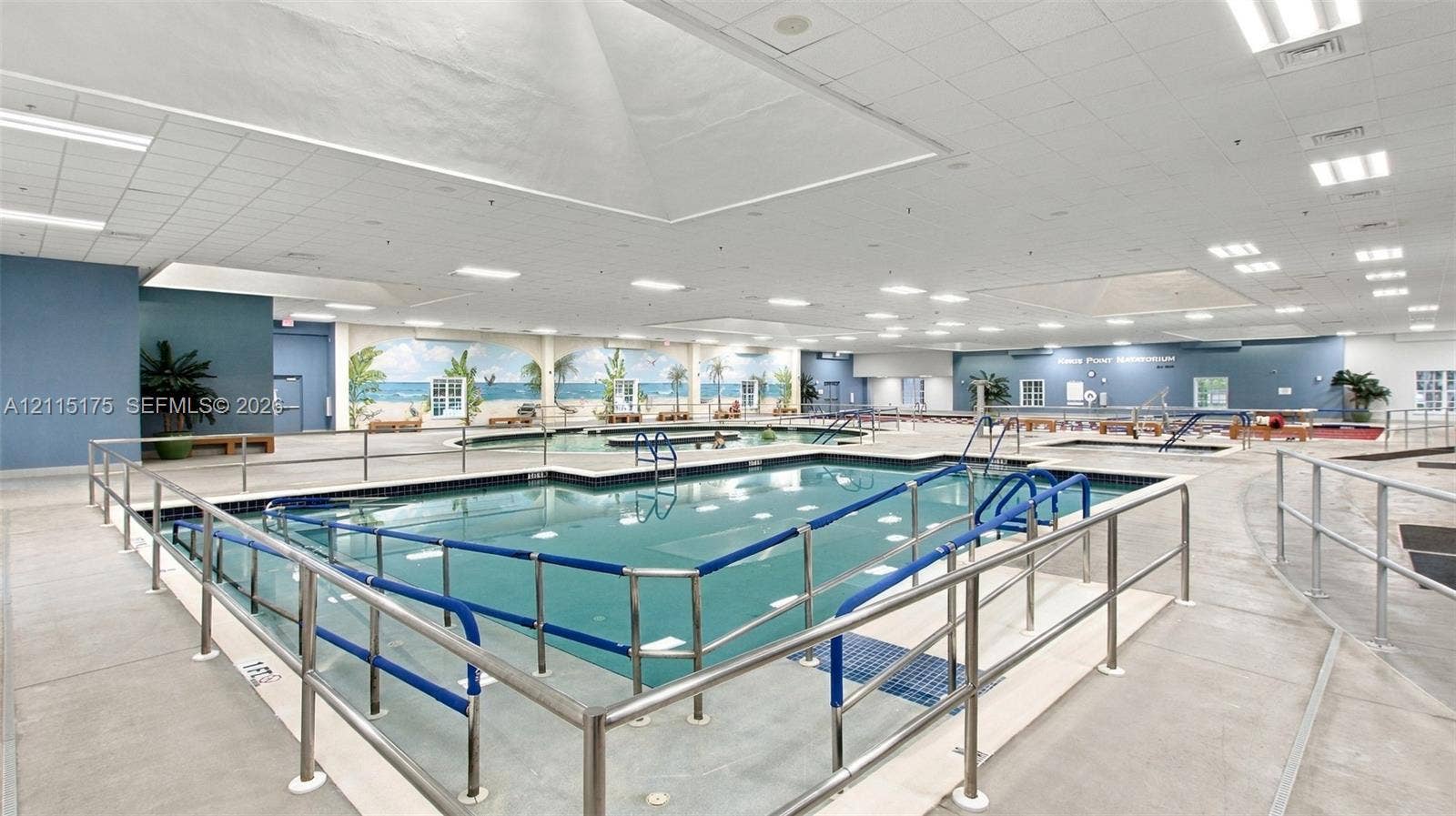 324 Seville N, Delray Beach, FL 33446 Natatorium with lap pool, wading pool, resistance pool and whirlpool. The facility also features a concrete deck, metal safety railings, integrated skylights, and ceiling-mounted lighting