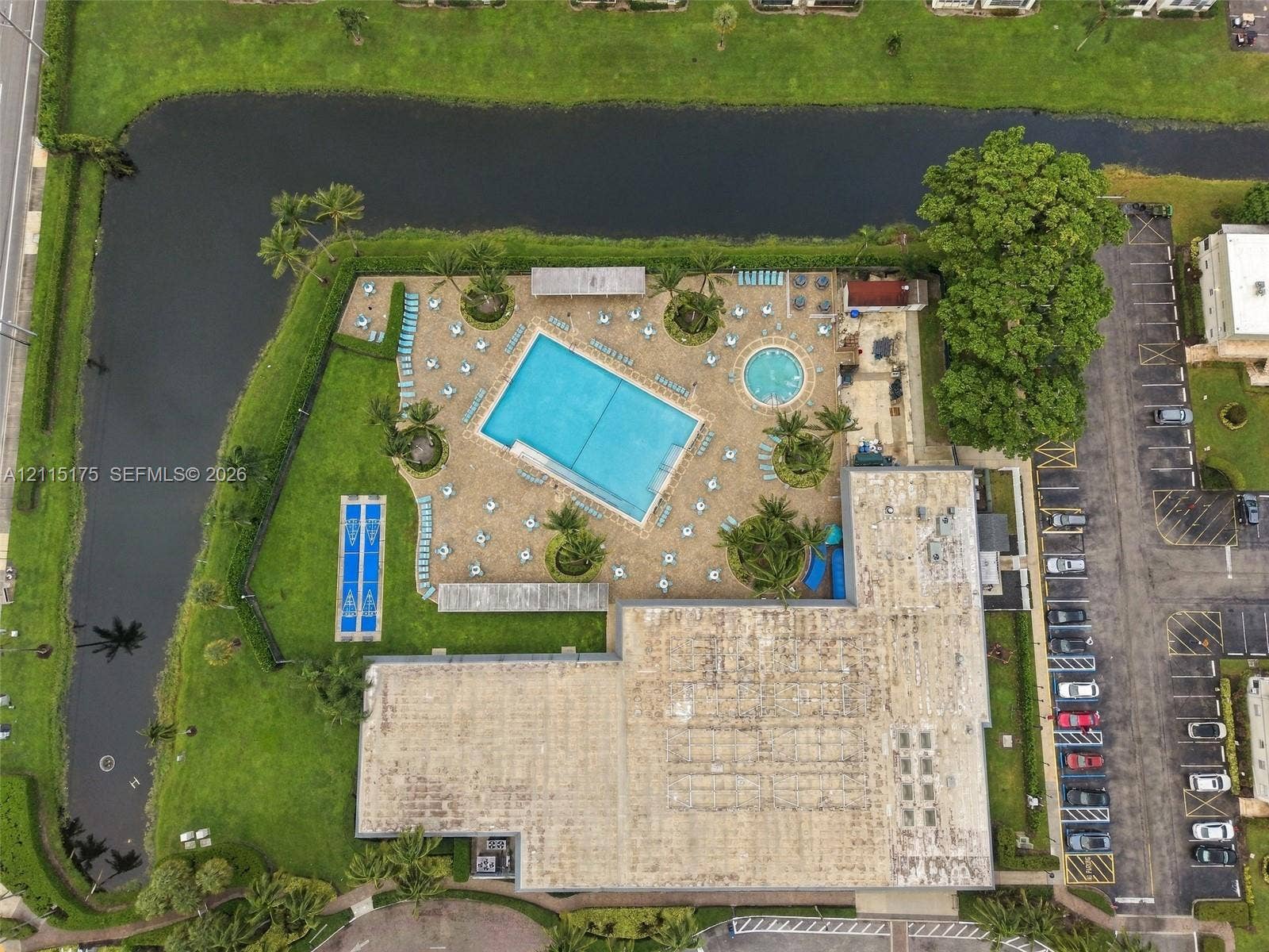 324 Seville N, Delray Beach, FL 33446 Aerial perspective of one of the satellite clubhouses with amenities including a swimming pool, hot tub, shuffleboard and paved sun deck