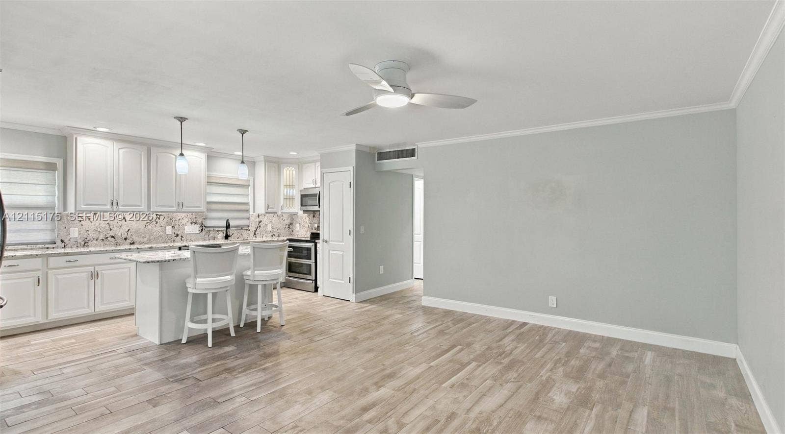 324 Seville N, Delray Beach, FL 33446 Open concept living area with porcelain tile wood-look flooring