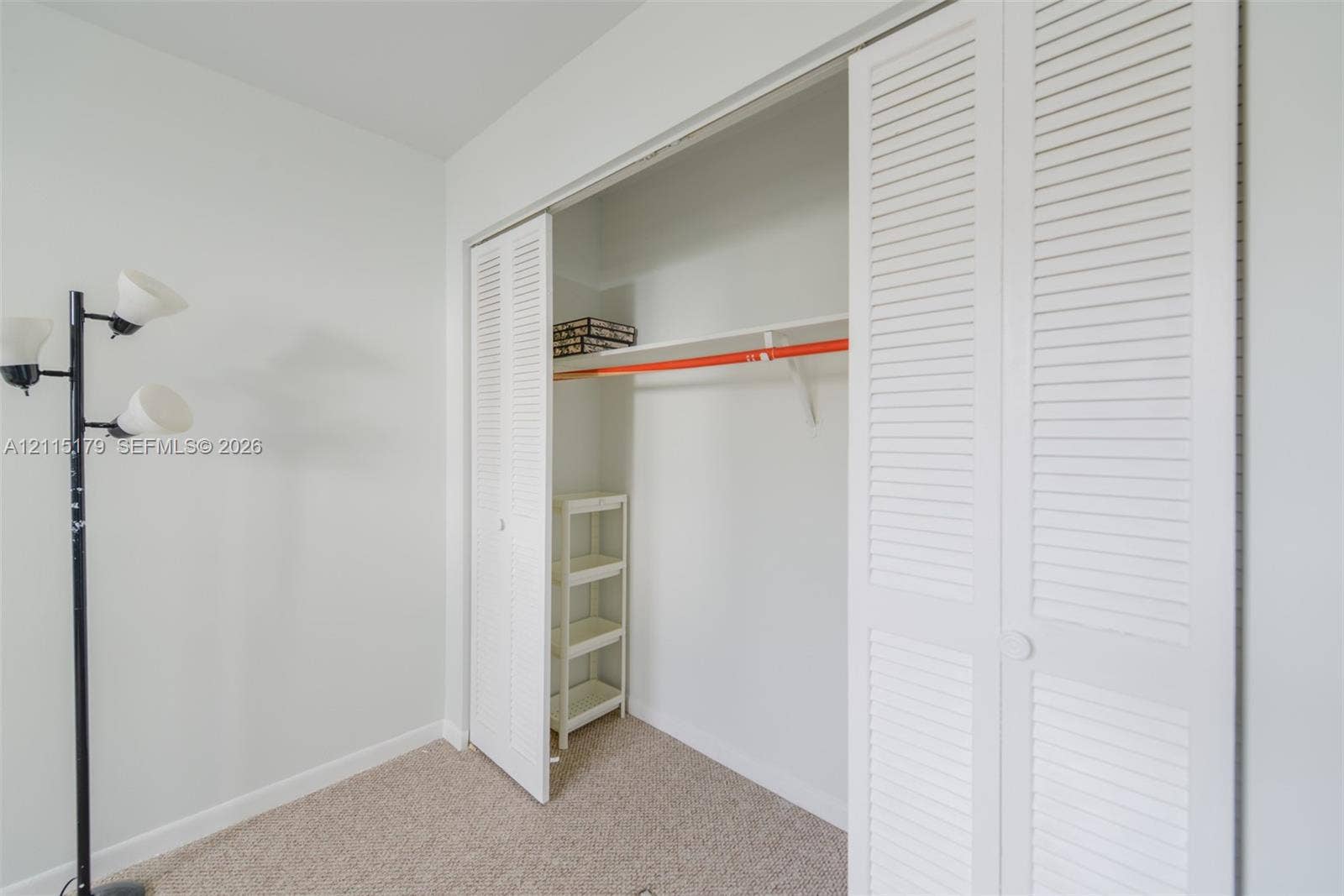 1849 S Ocean Drive, #407, Hallandale Beach, Hallandale Beach, FL 33009 Closet featuring white louvered bifold doors, an integrated hanging rod, and a built-in overhead shelf