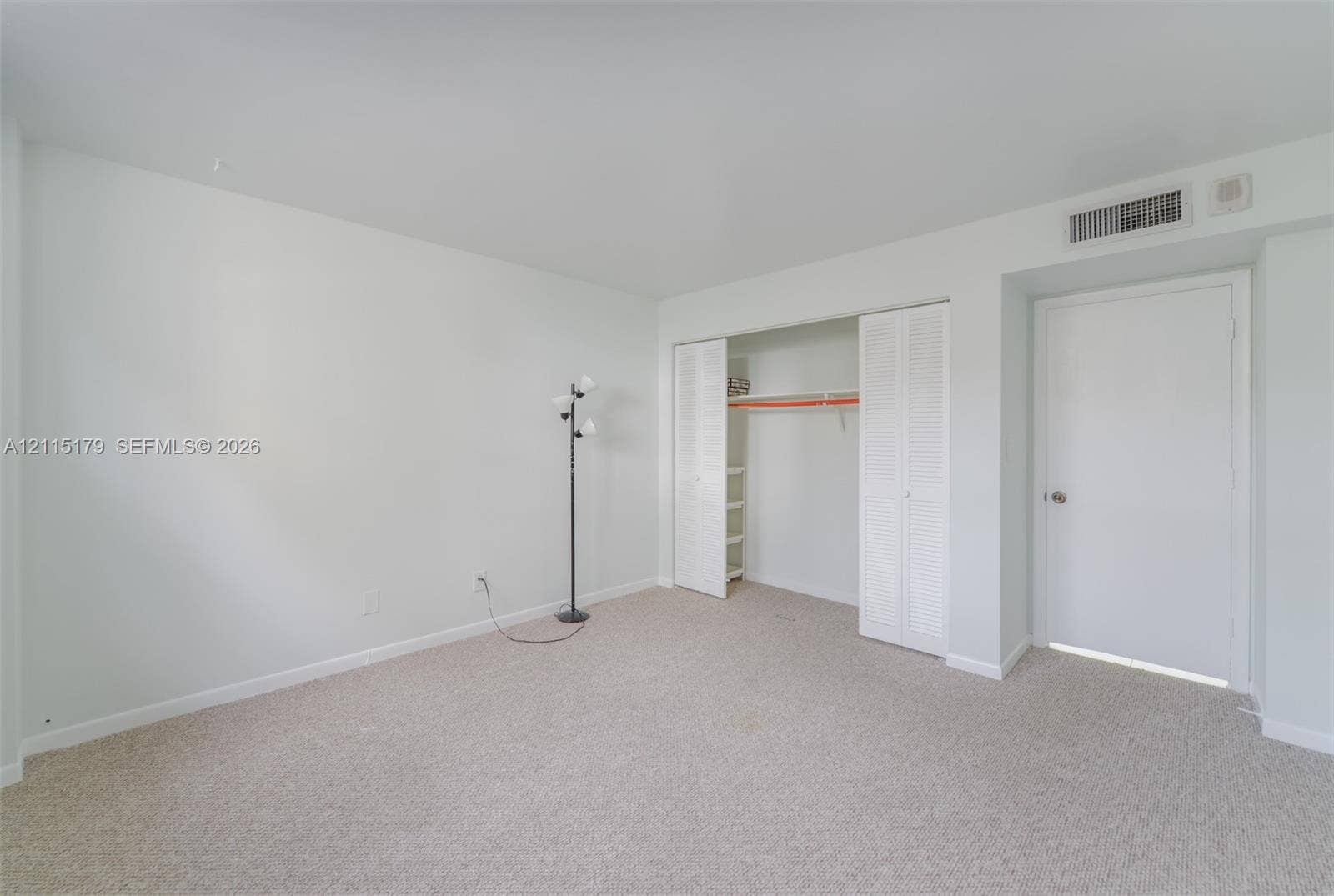 1849 S Ocean Drive, #407, Hallandale Beach, Hallandale Beach, FL 33009 Neutral-toned carpeting, white walls, and a closet with bifold louvered doors