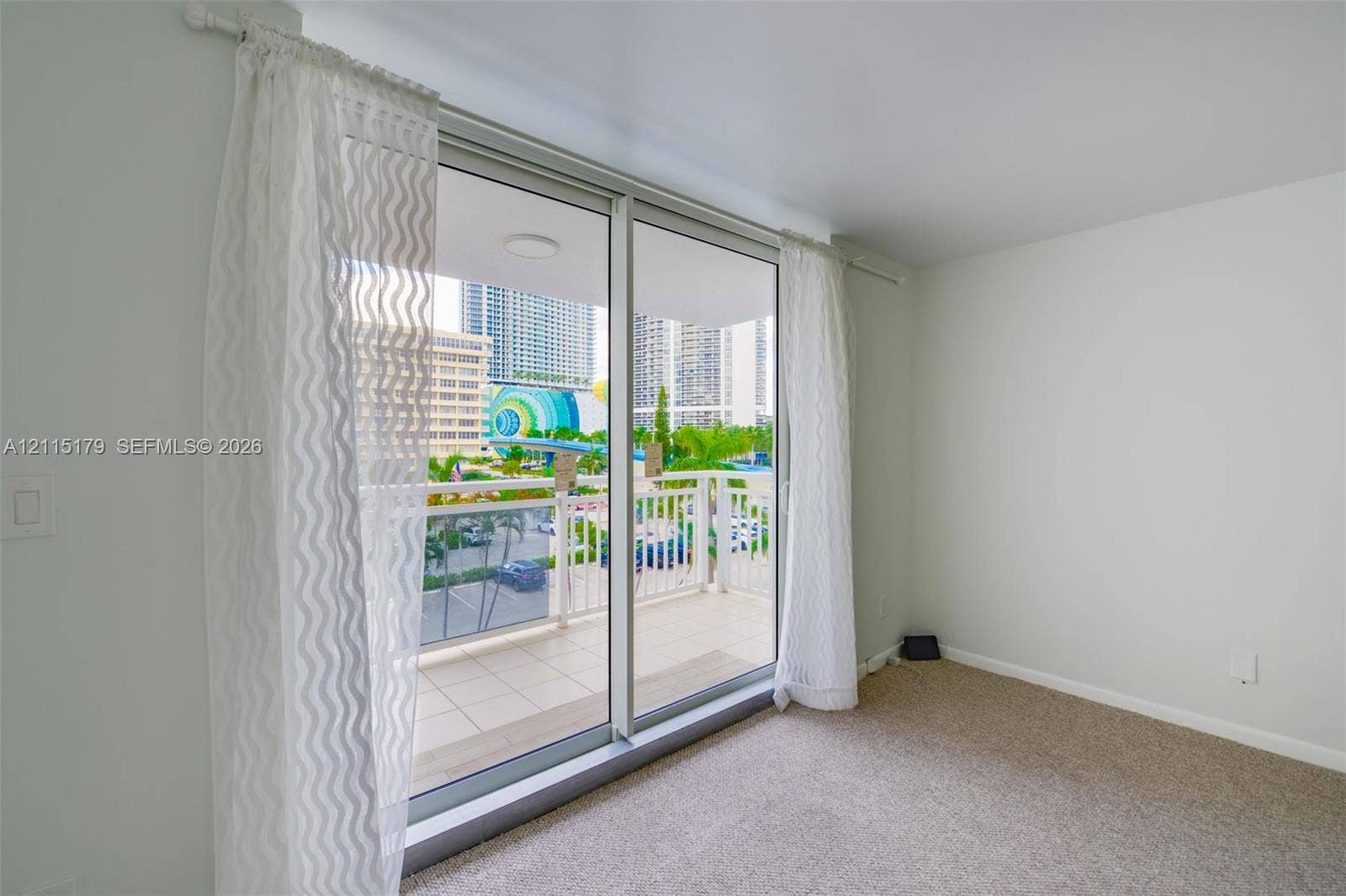 1849 S Ocean Drive, #407, Hallandale Beach, Hallandale Beach, FL 33009 Floor-to-ceiling glass sliding doors opening to a private balcony featuring a metal railing