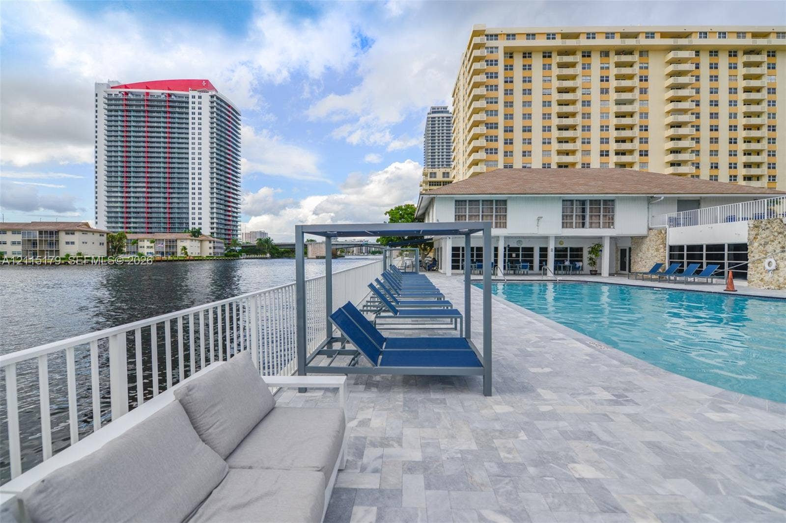 1849 S Ocean Drive, #407, Hallandale Beach, Hallandale Beach, FL 33009 Waterfront swimming pool with light stone paver decking and white metal perimeter railing