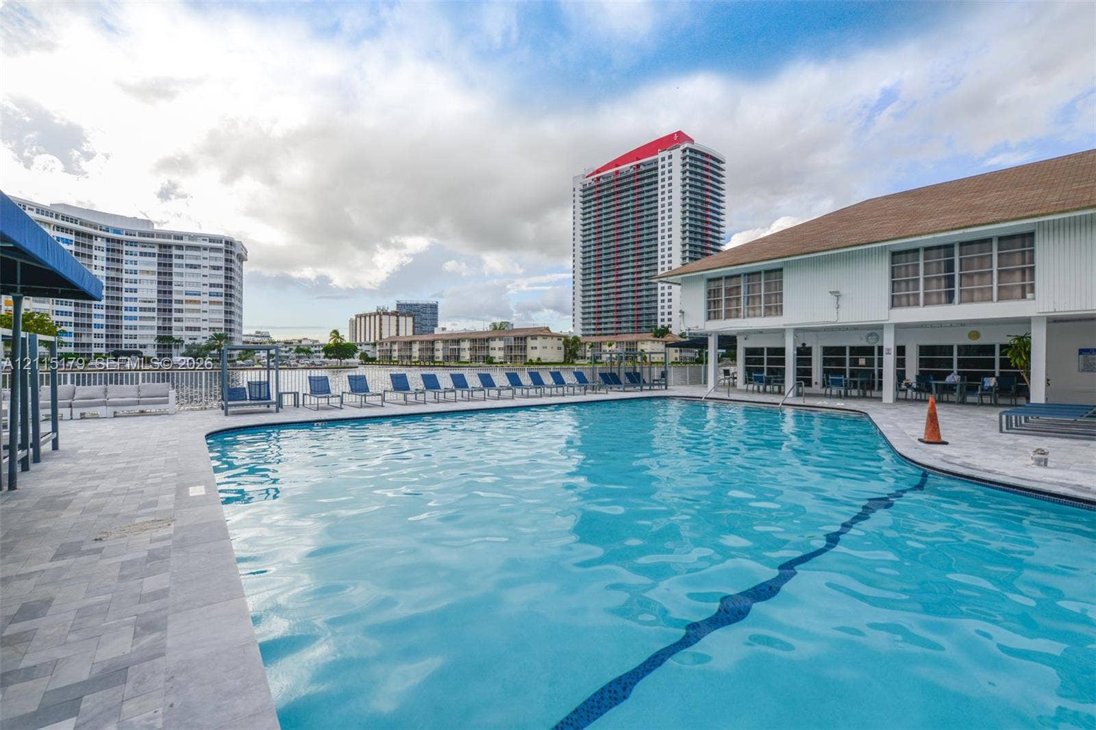 1849 S Ocean Drive, #407, Hallandale Beach, Hallandale Beach, FL 33009 Swimming pool with stone paver decking, multi-story building exterior, and waterfront placement
