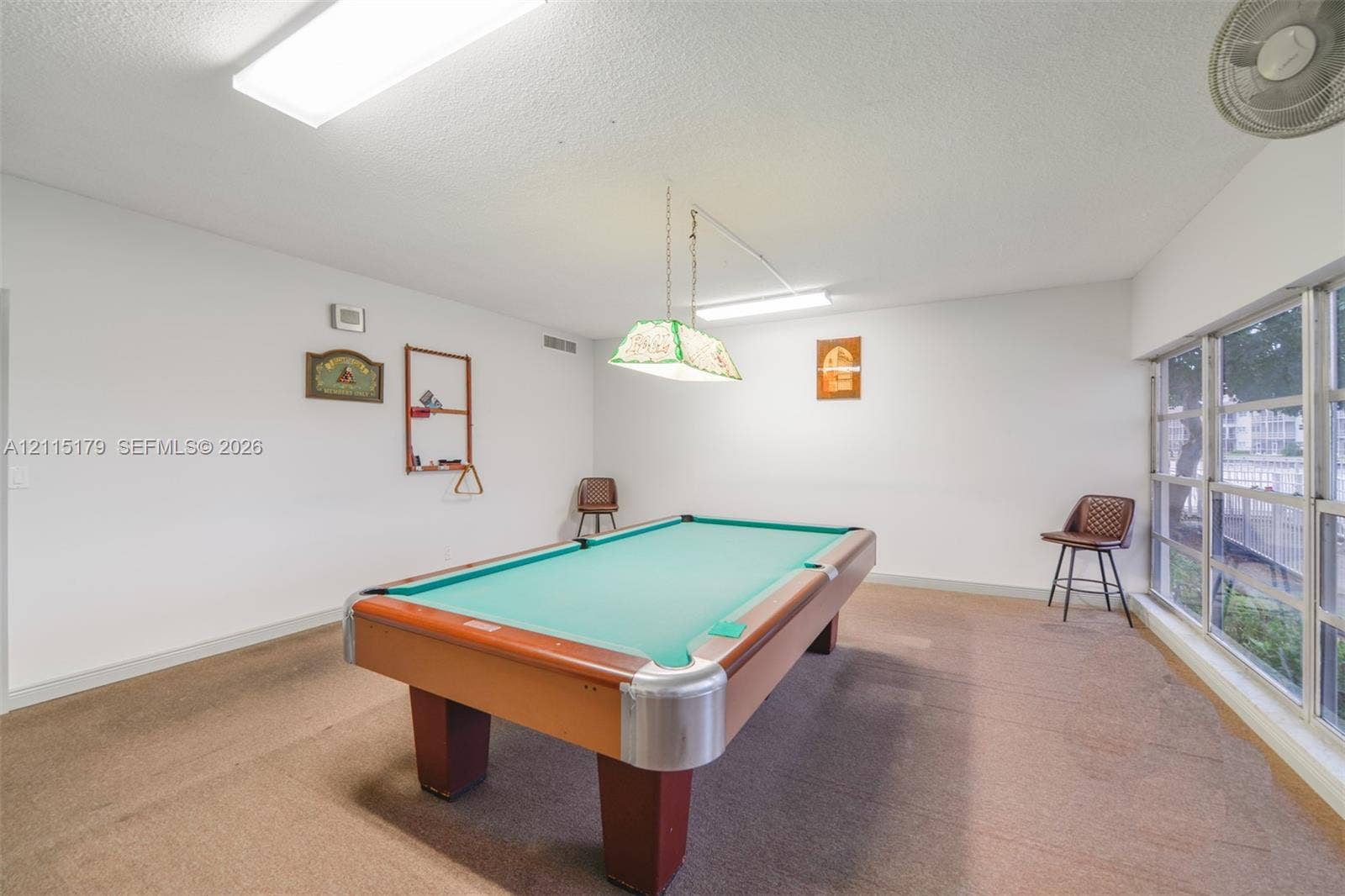 1849 S Ocean Drive, #407, Hallandale Beach, Hallandale Beach, FL 33009 Expansive interior room featuring floor-to-ceiling windows, wall-to-wall carpeting, and a dual-pendant billiard light fixture