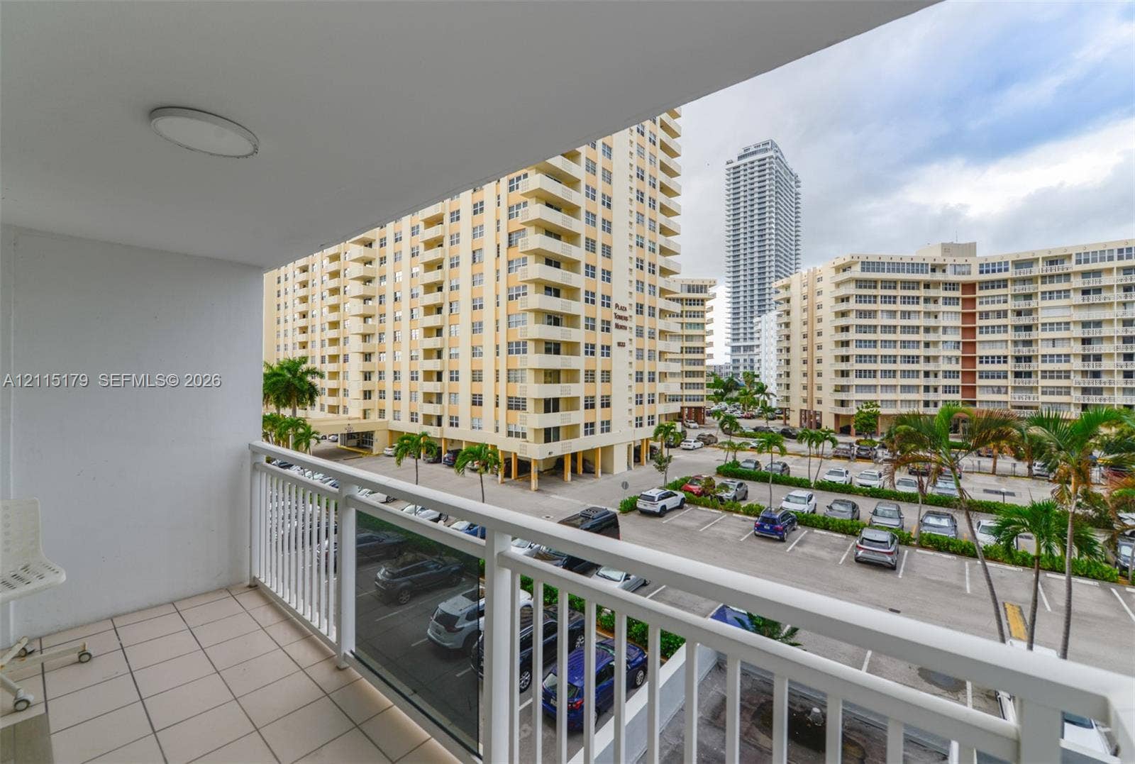 1849 S Ocean Drive, #407, Hallandale Beach, Hallandale Beach, FL 33009 Covered balcony with white metal railings and tiled flooring