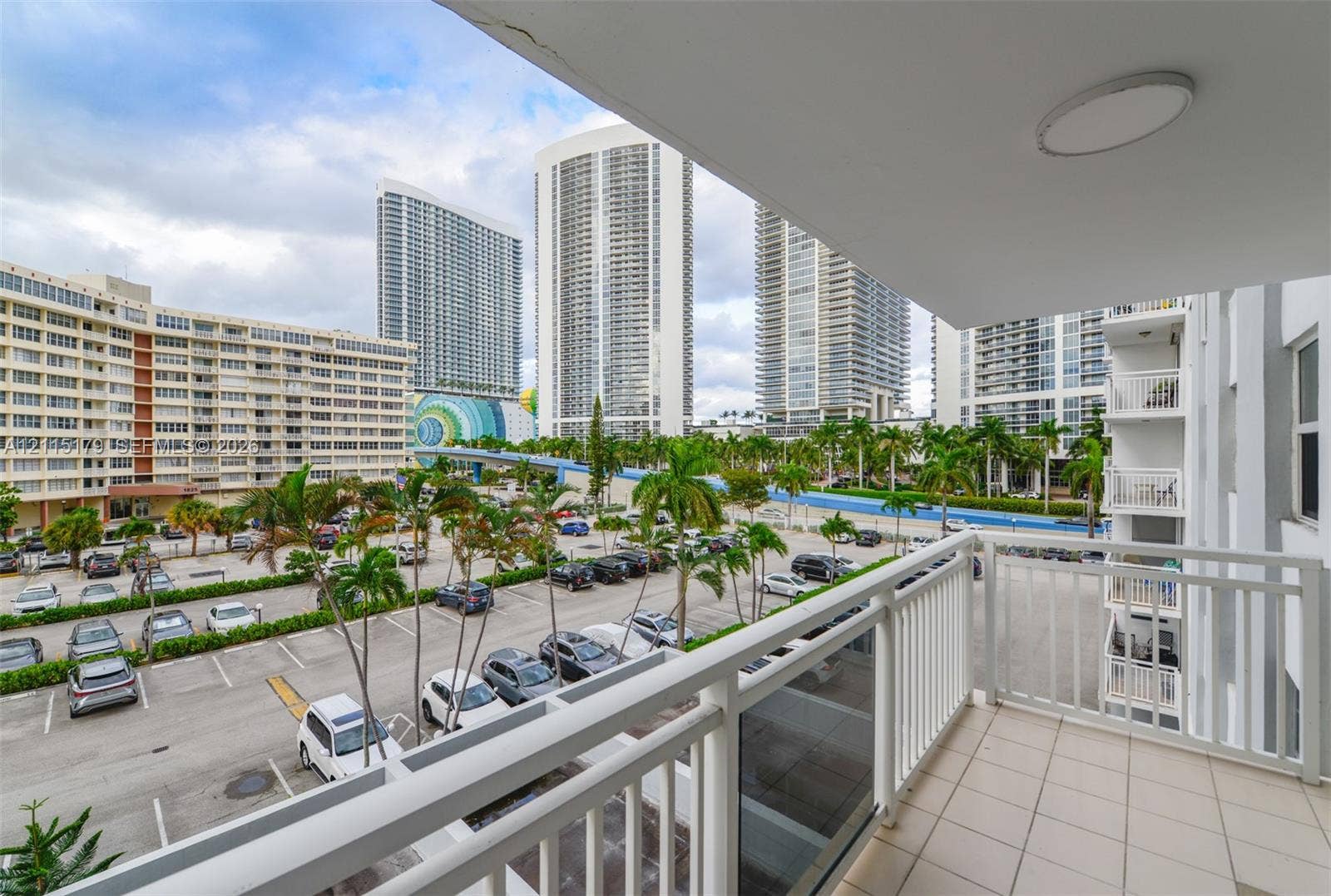 1849 S Ocean Drive, #407, Hallandale Beach, Hallandale Beach, FL 33009 Covered balcony featuring white vertical railings, a tiled floor, and ceiling-mounted lighting
