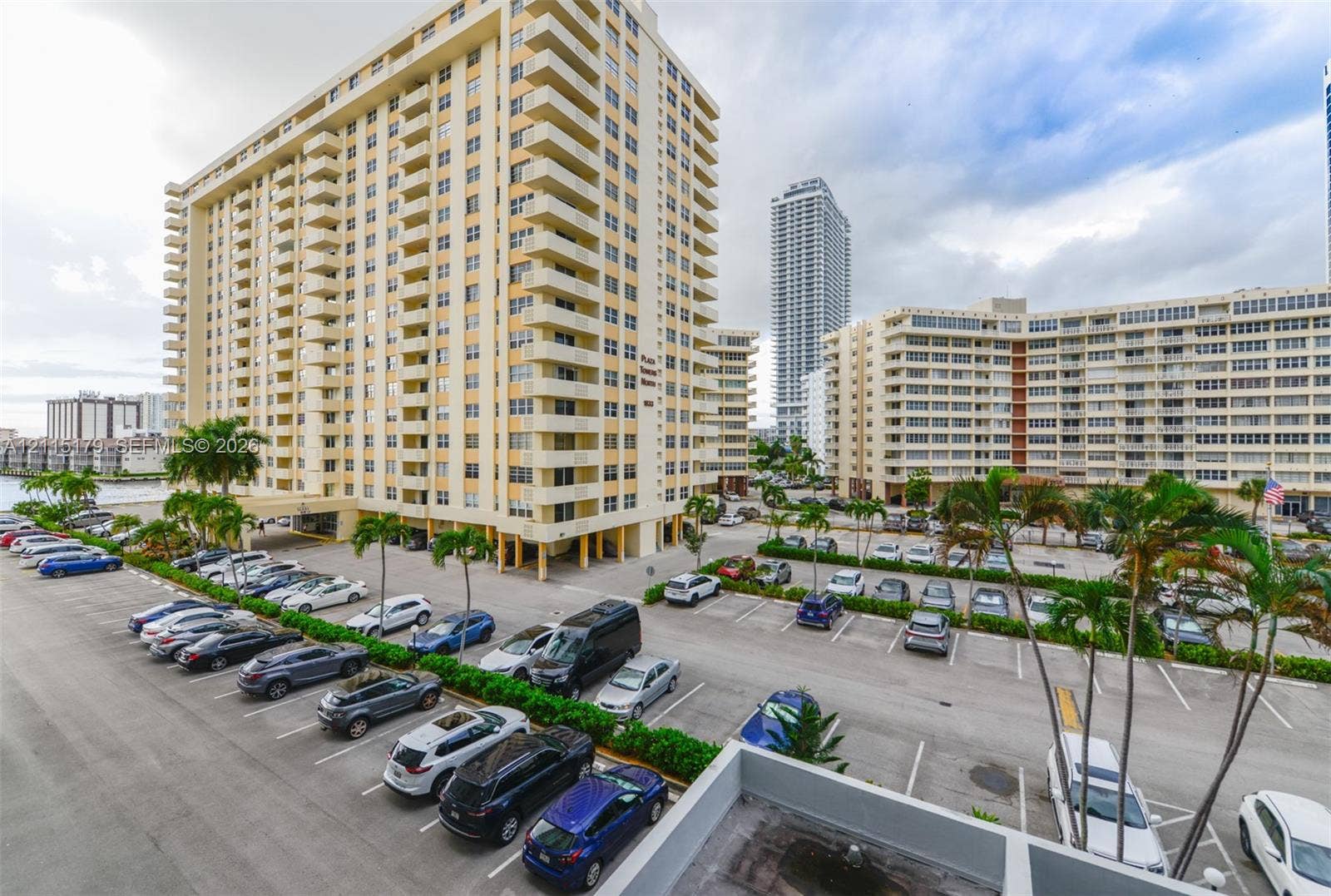 1849 S Ocean Drive, #407, Hallandale Beach, Hallandale Beach, FL 33009 High-rise residential exterior featuring private balconies, surface parking, and manicured landscaping