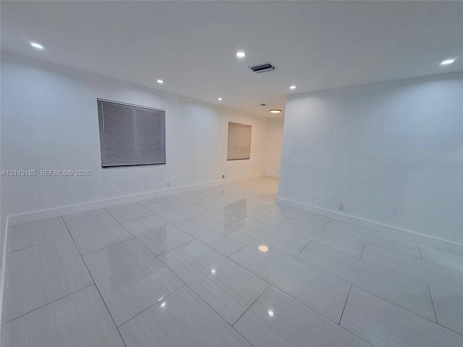 105-107 NE 30th Court, Wilton Manors, FL 33334 Large-format rectified tile flooring, recessed ceiling lighting, and neutral wall finishes