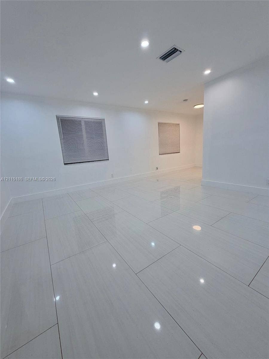 105-107 NE 30th Court, Wilton Manors, FL 33334 Large-format white tile flooring, recessed ceiling lighting, and crisp neutral wall finish