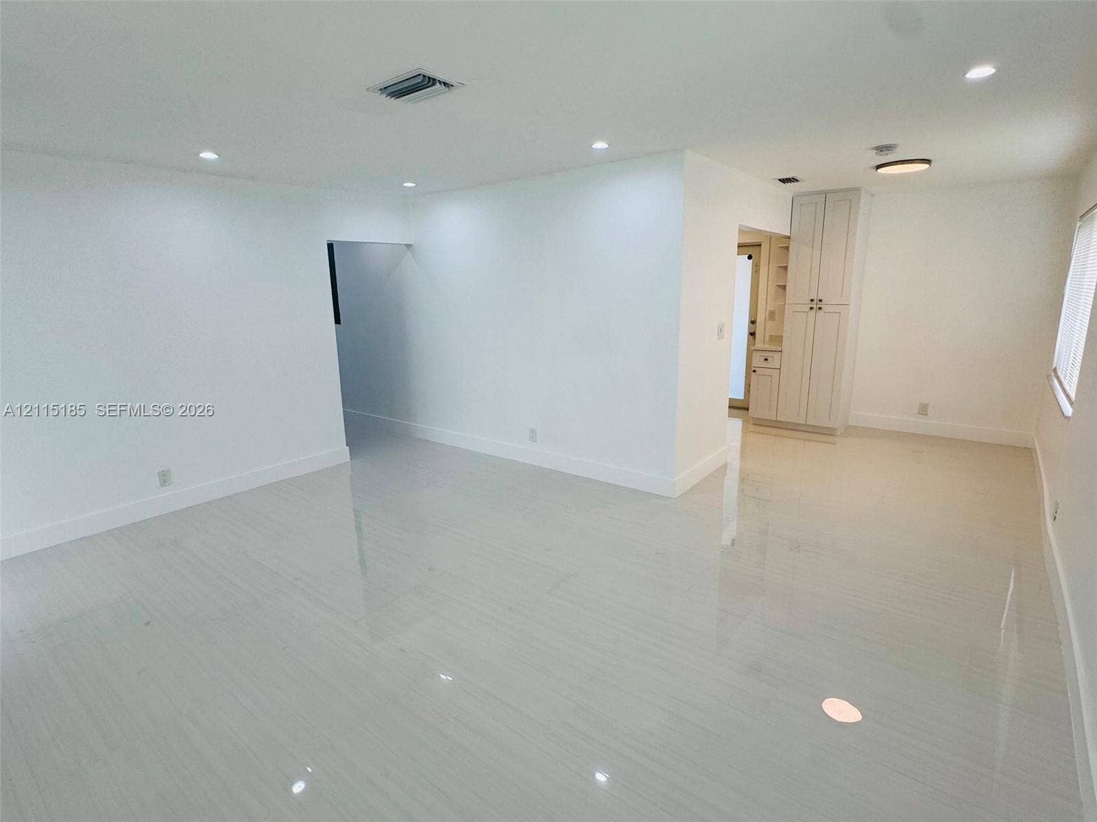 105-107 NE 30th Court, Wilton Manors, FL 33334 Neutral-toned tile flooring, recessed ceiling lighting, and built-in floor-to-ceiling cabinetry