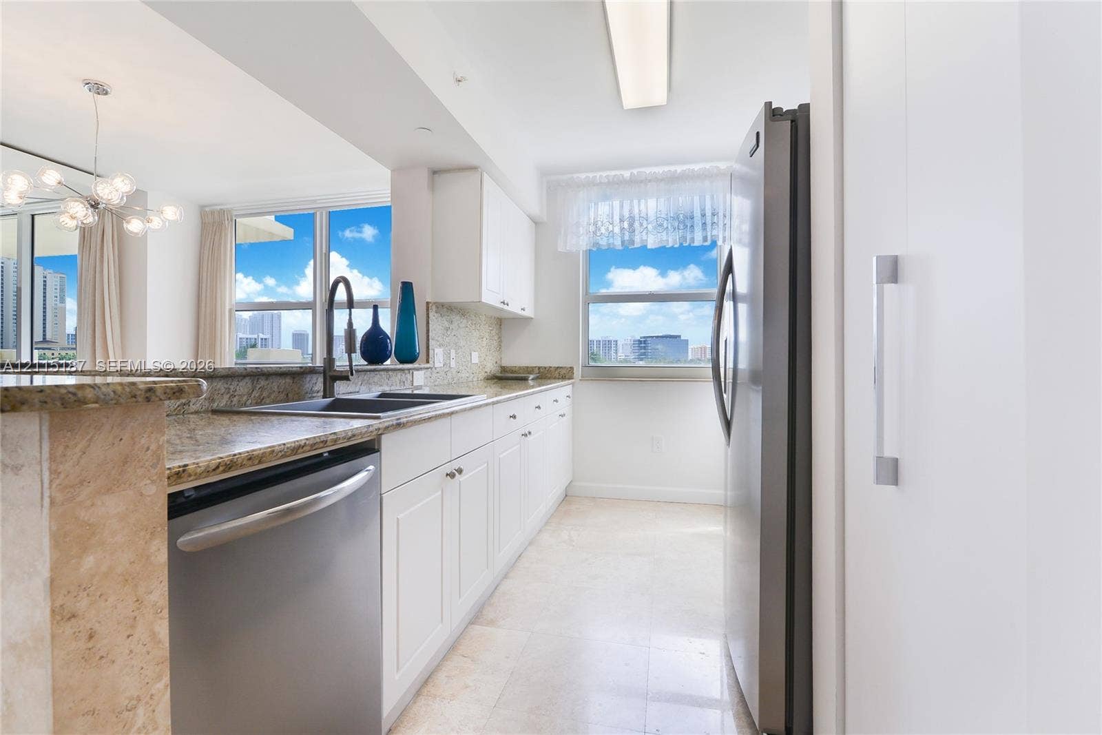 19501 W Country Club Drive, #504, Aventura, Aventura, FL 33180 Kitchen featuring white cabinetry, stone countertops, stainless steel appliances, a double-basin undermount sink, and tile flooring