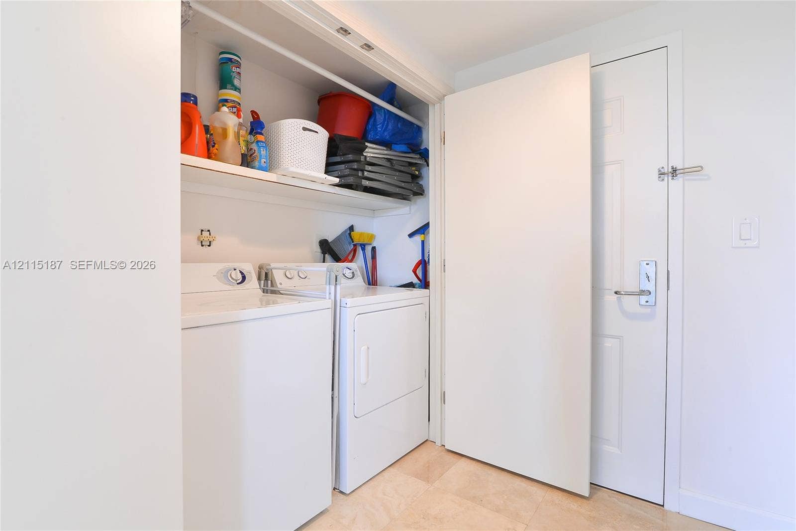 19501 W Country Club Drive, #504, Aventura, Aventura, FL 33180 Laundry area featuring built-in overhead shelving, a side-by-side washer and dryer, and a neutral tile floor